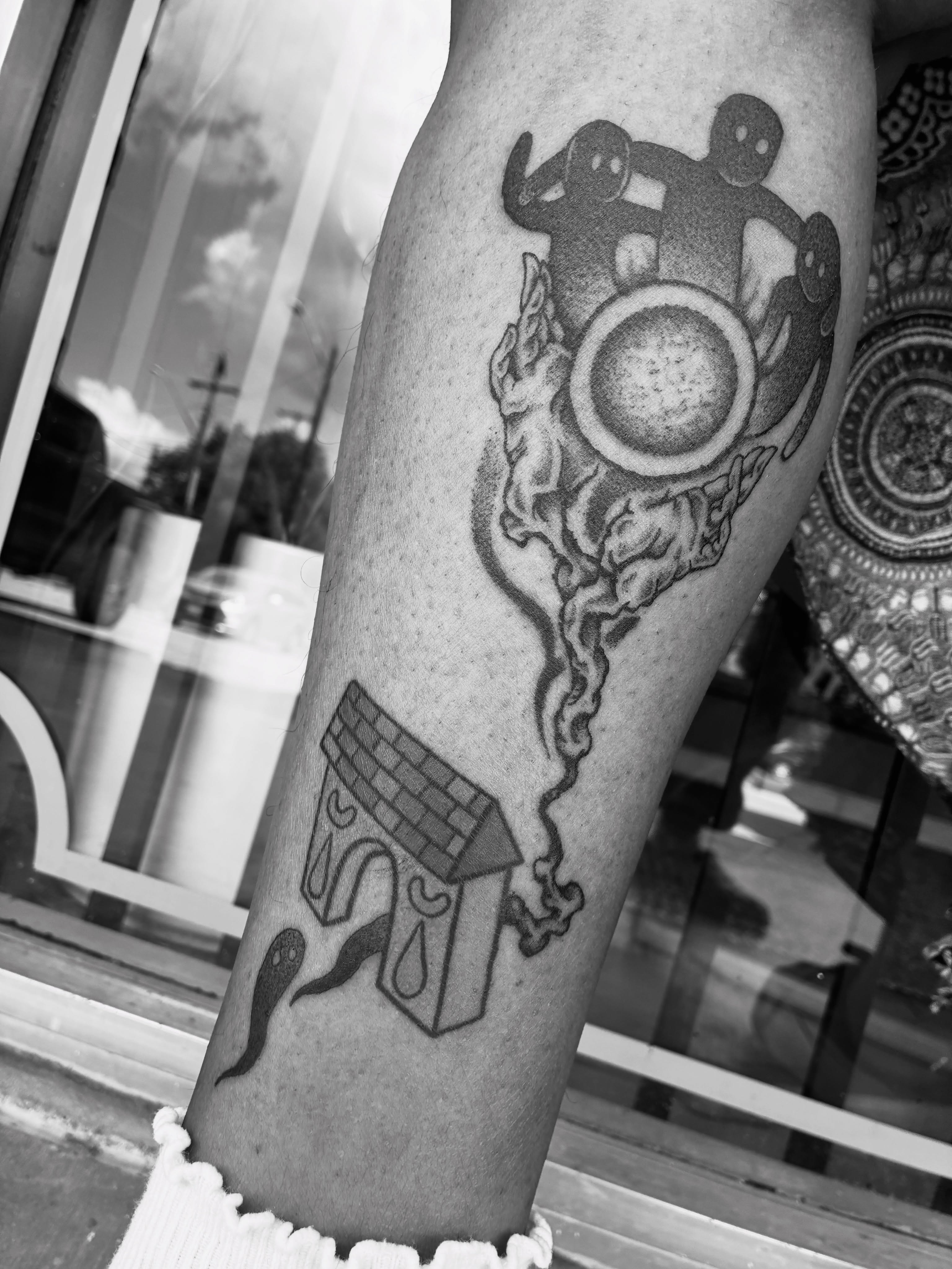 Astronaut and celestial body black and grey tattoo on the forearm by Zachary R Bobkoff