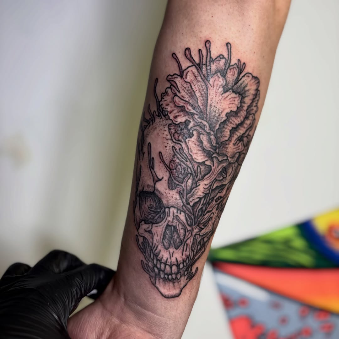Skull with floral elements dotwork tattoo on the forearm by Taylor  Thompson