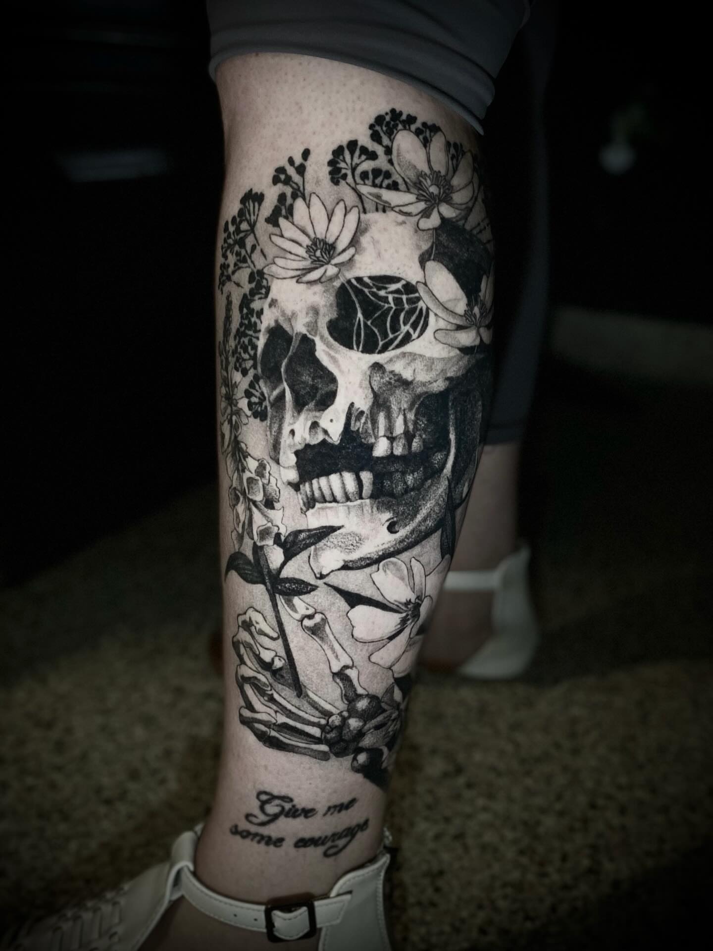 Skull and flowers realism tattoo on the calf by Olivia Scott - Kansas Tattoo Artist