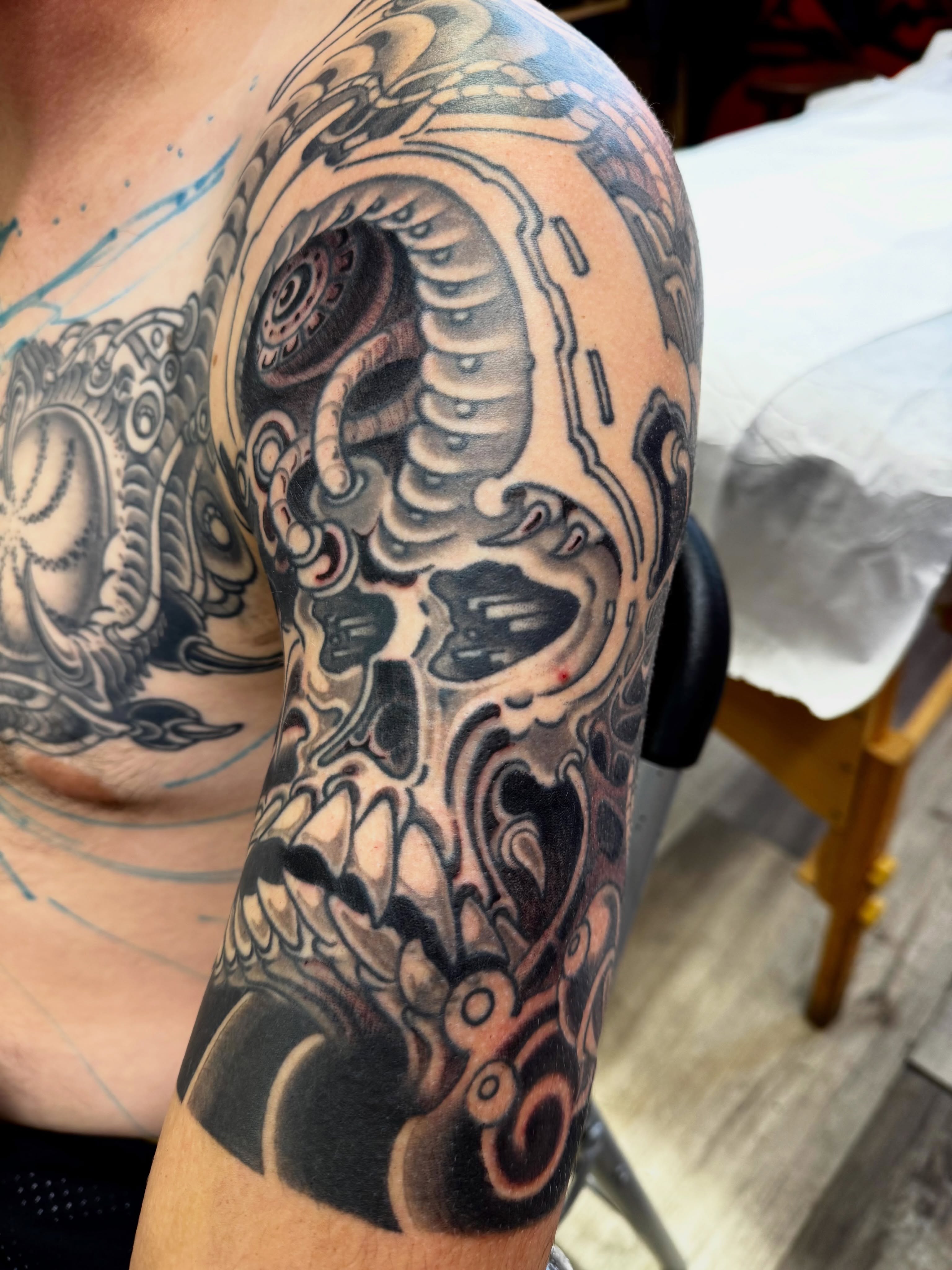 Mechanical skull geometric tattoo on the forearm by Chris Orta