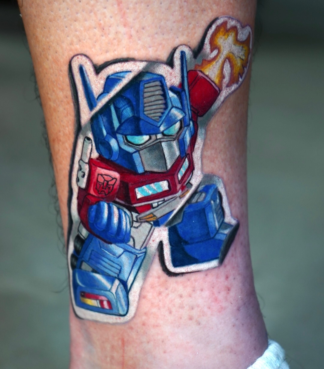 Optimus prime realism tattoo on the forearm by Benjamin Xavier Valadez