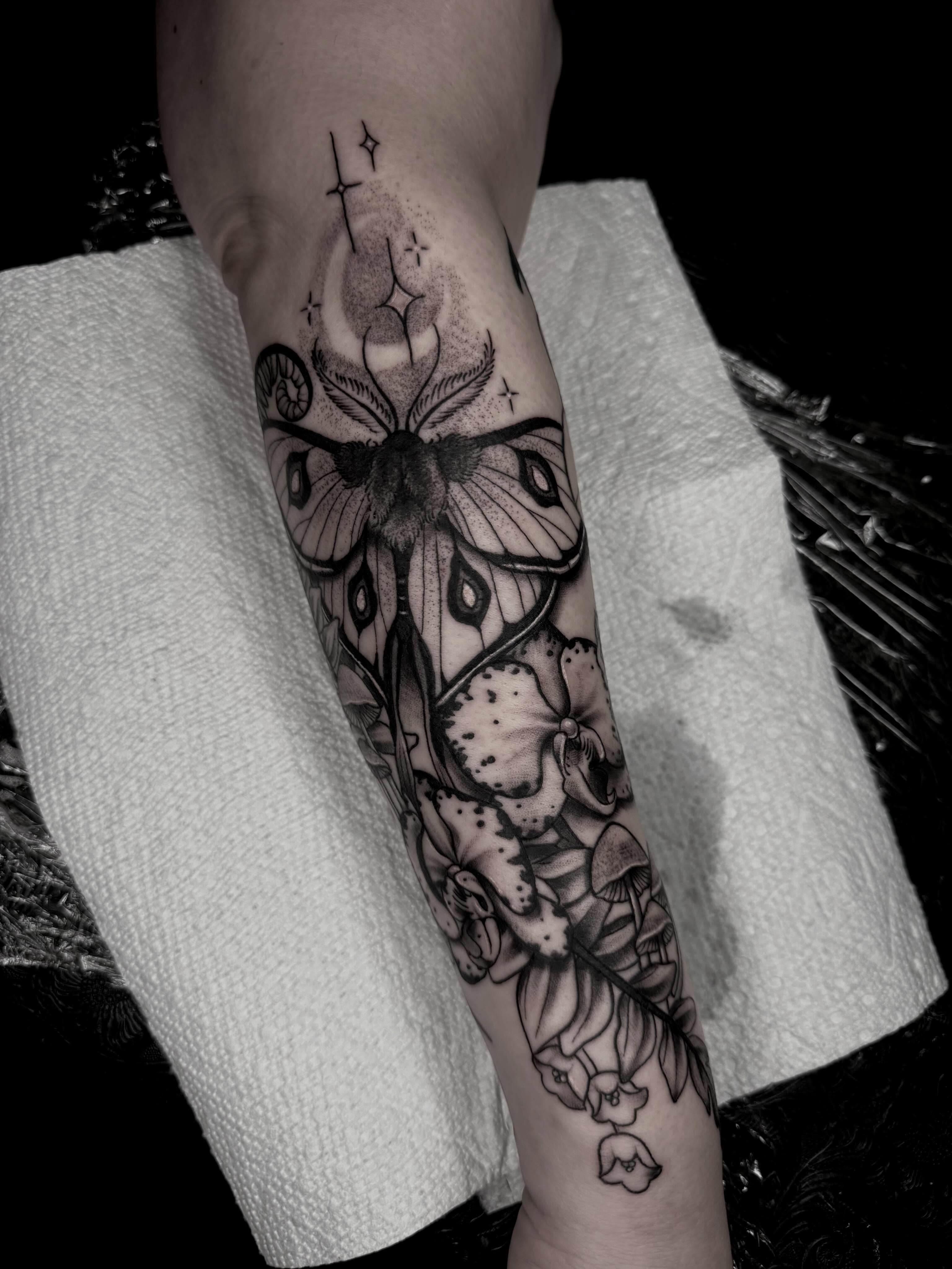 Moth and flowers dotwork tattoo on the forearm by Emma Mathis, Springfield, Oregon