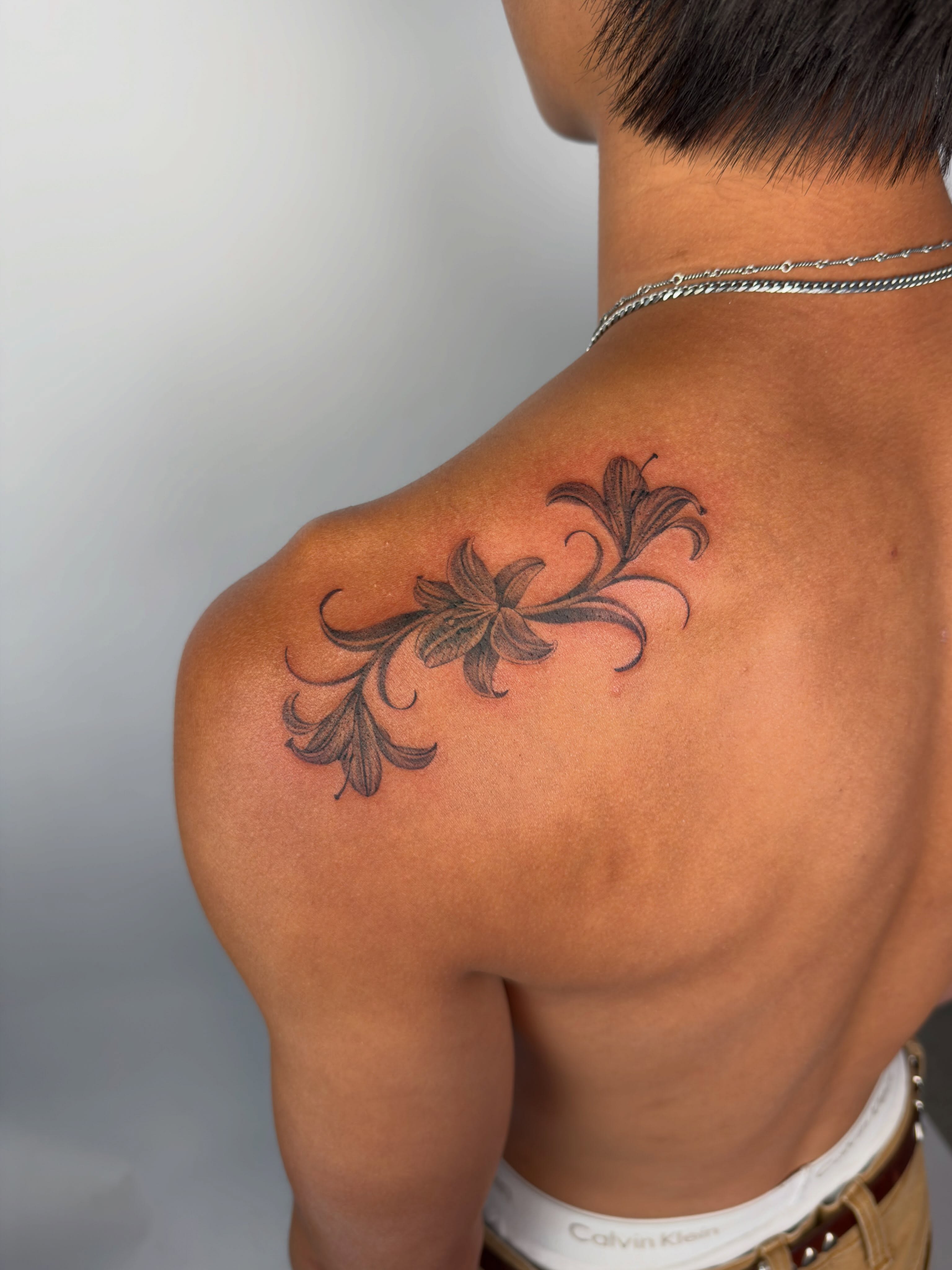 Lily black and grey tattoo on the shoulder by Nayoung, San Francisco, California