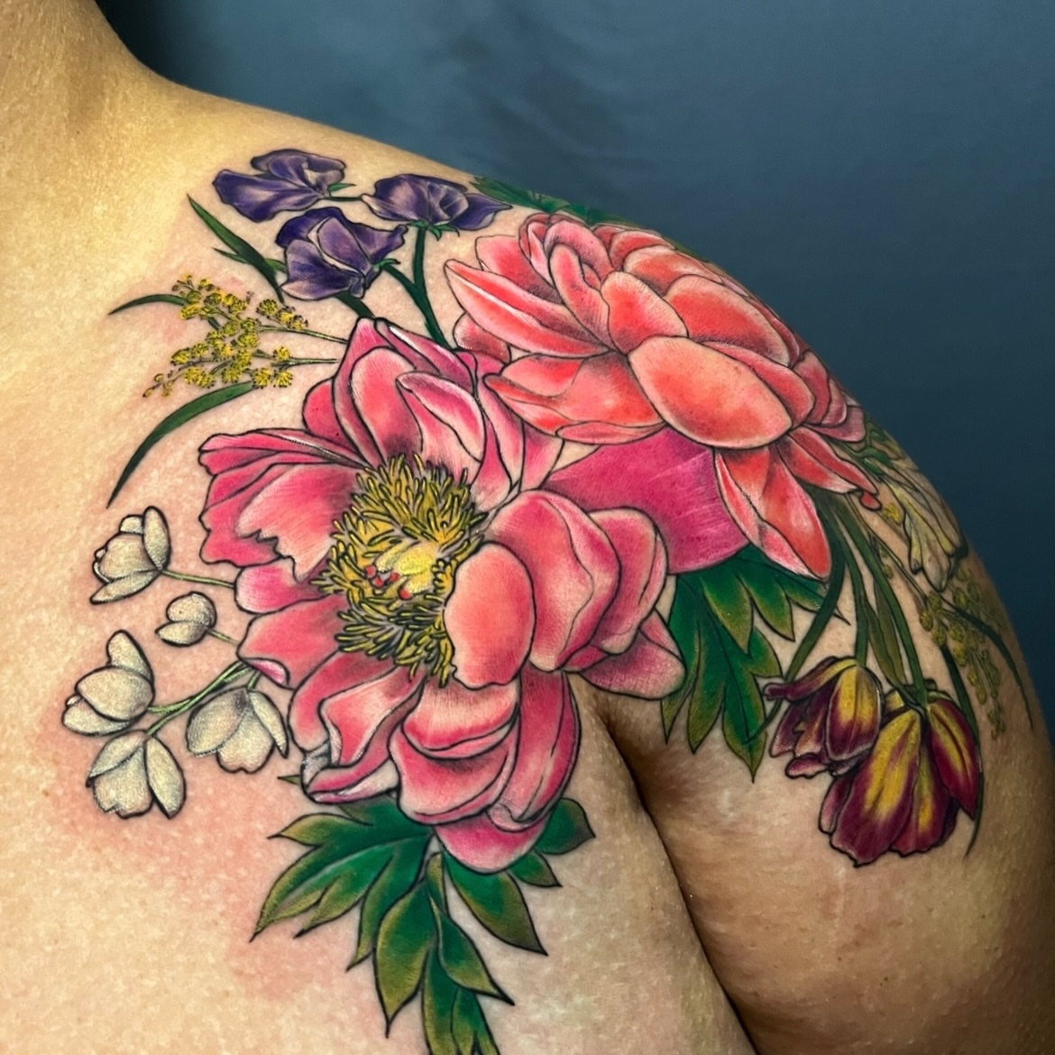 Floral bouquet realism tattoo on the shoulder by Jen Rahman