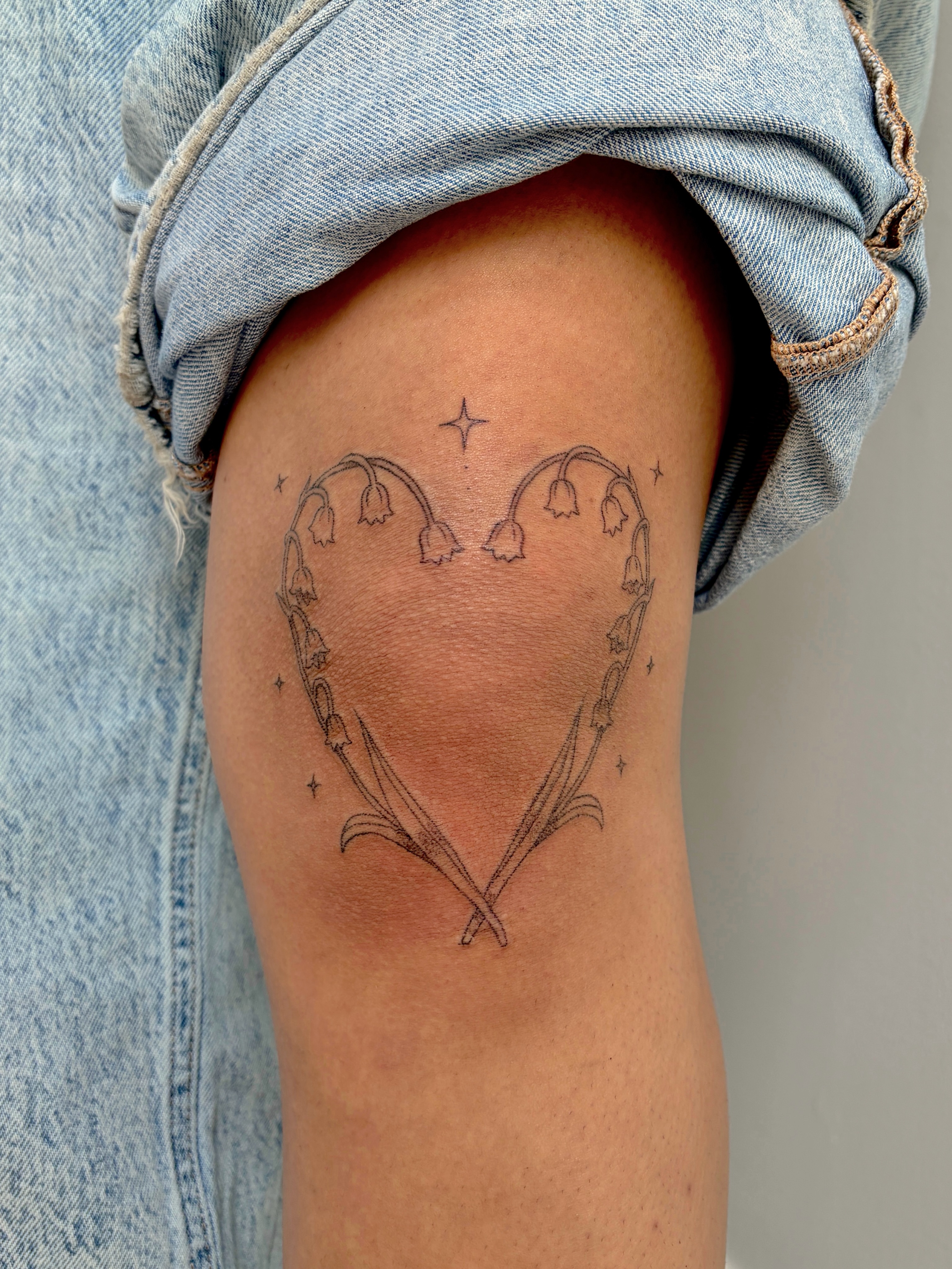Bell flowers in heart shape fine line tattoo on the thigh by alli ミ☆