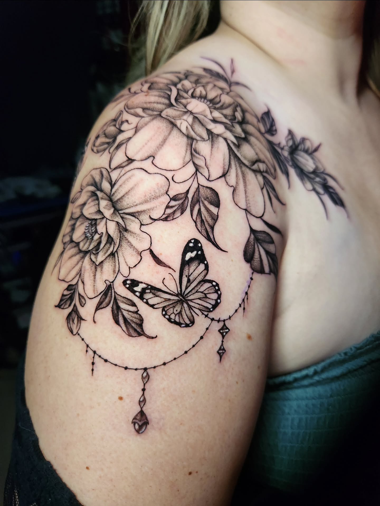 Butterfly and floral bouquet realism tattoo on the shoulder by Abby Renteria