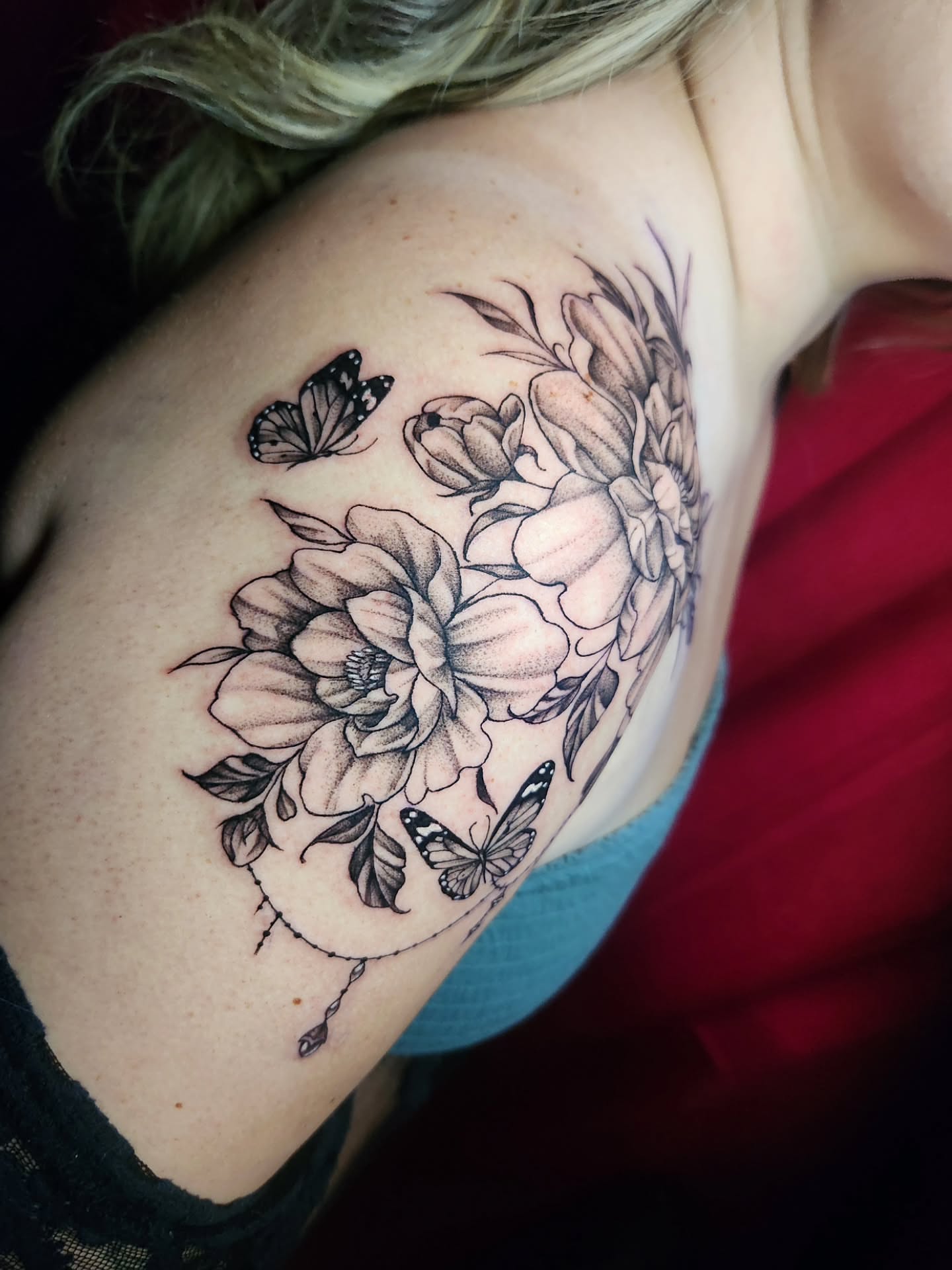 Flowers and butterflies dotwork tattoo on the shoulder by Abby Renteria