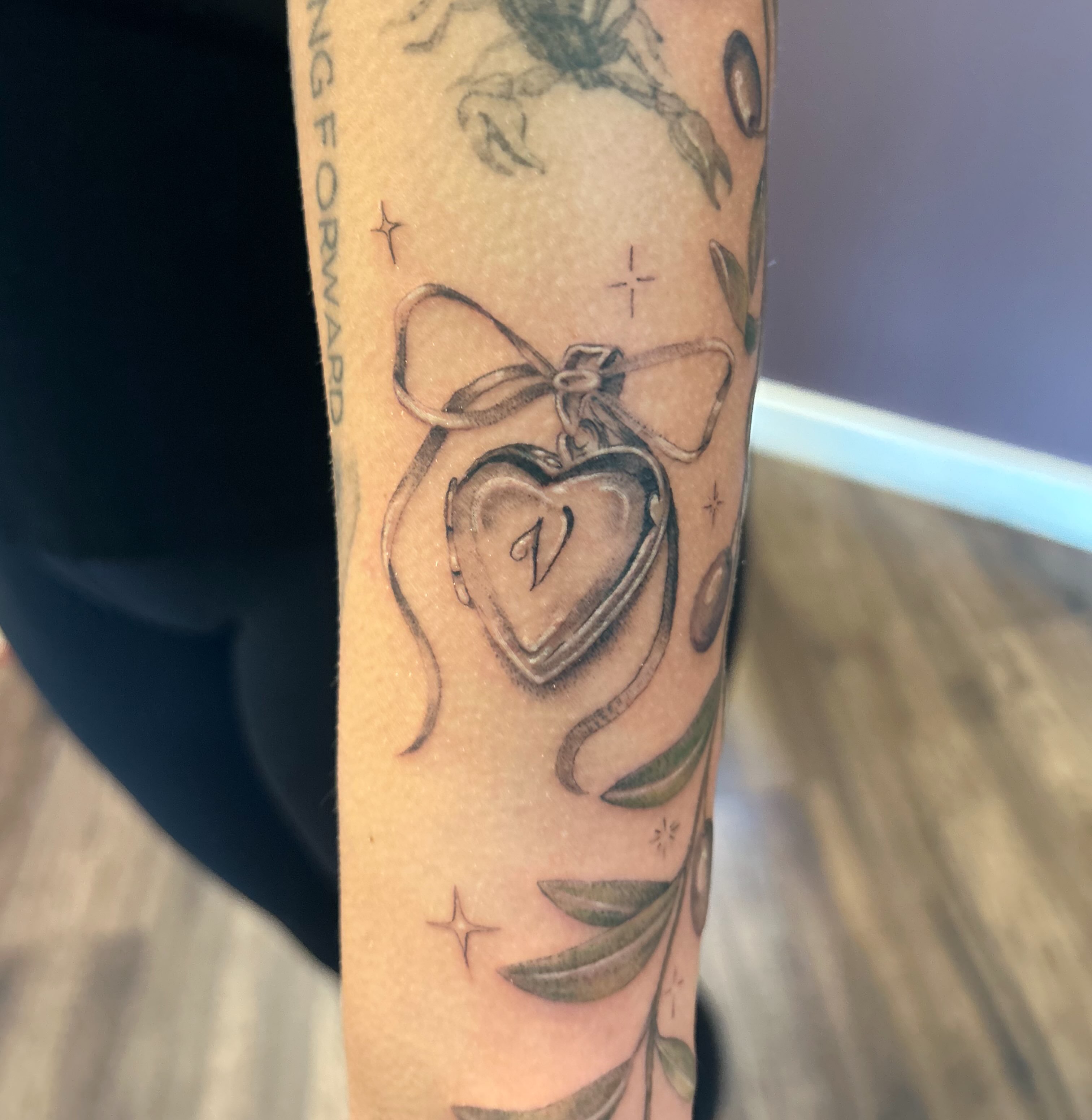 Heart locket black and grey tattoo on the forearm by Elizabeth (Lib), Murfreesboro, Tennessee