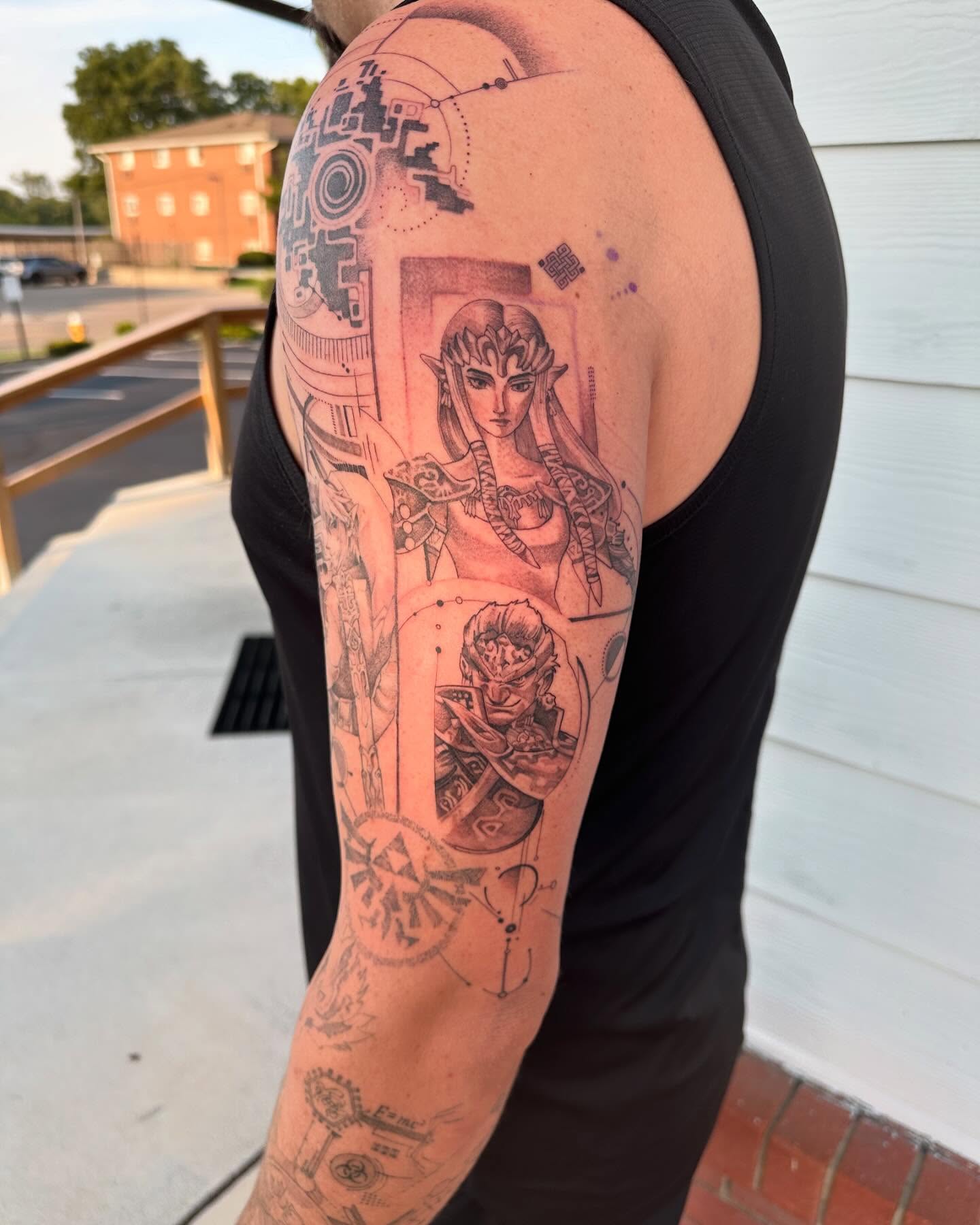 Zelda and ganondorf anime tattoo on the upper arm by Cassandra Rasper-Beard