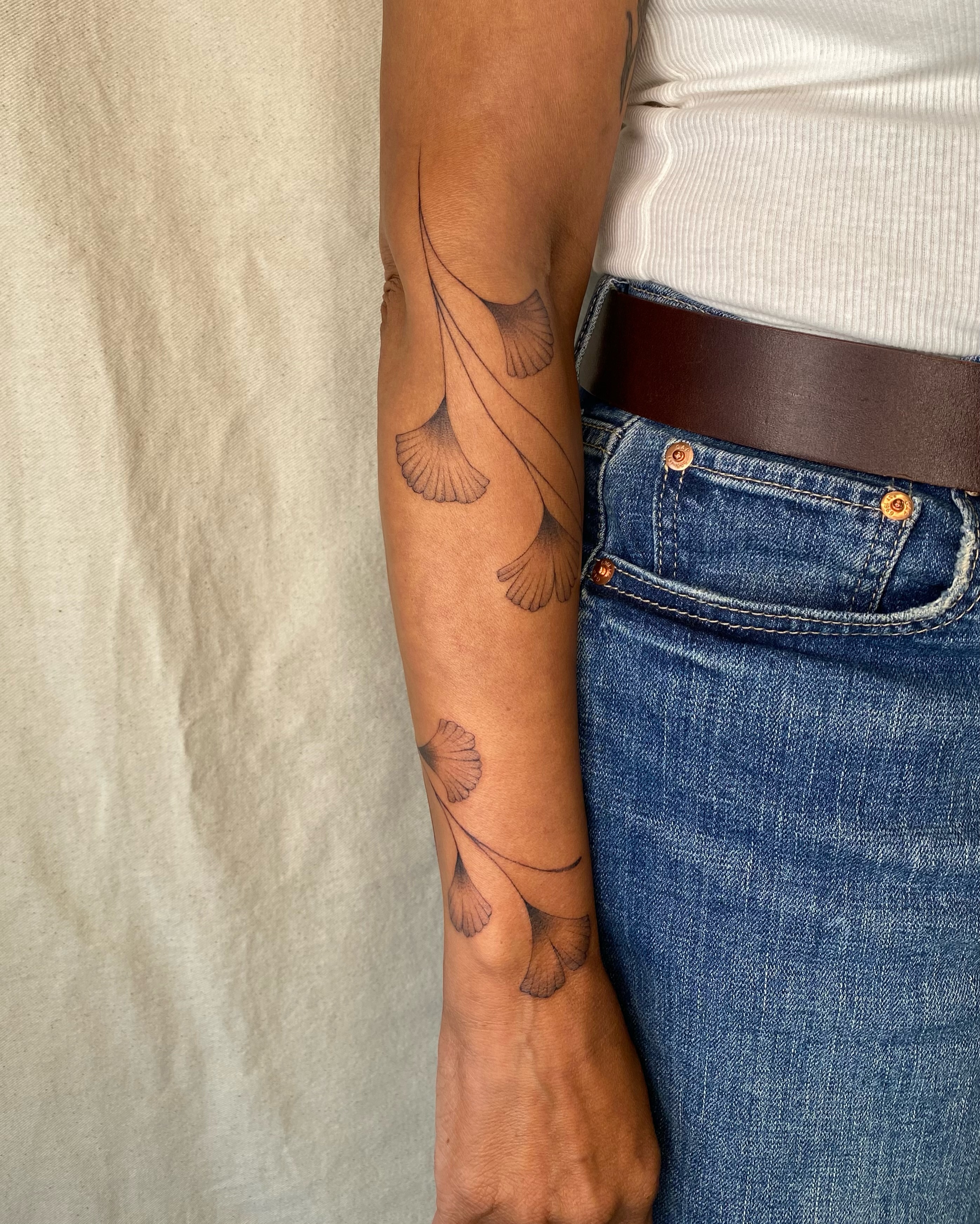 Gingko leaves black and grey tattoo on the forearm by Sasha 🪆 Southern California Tattoo Artist