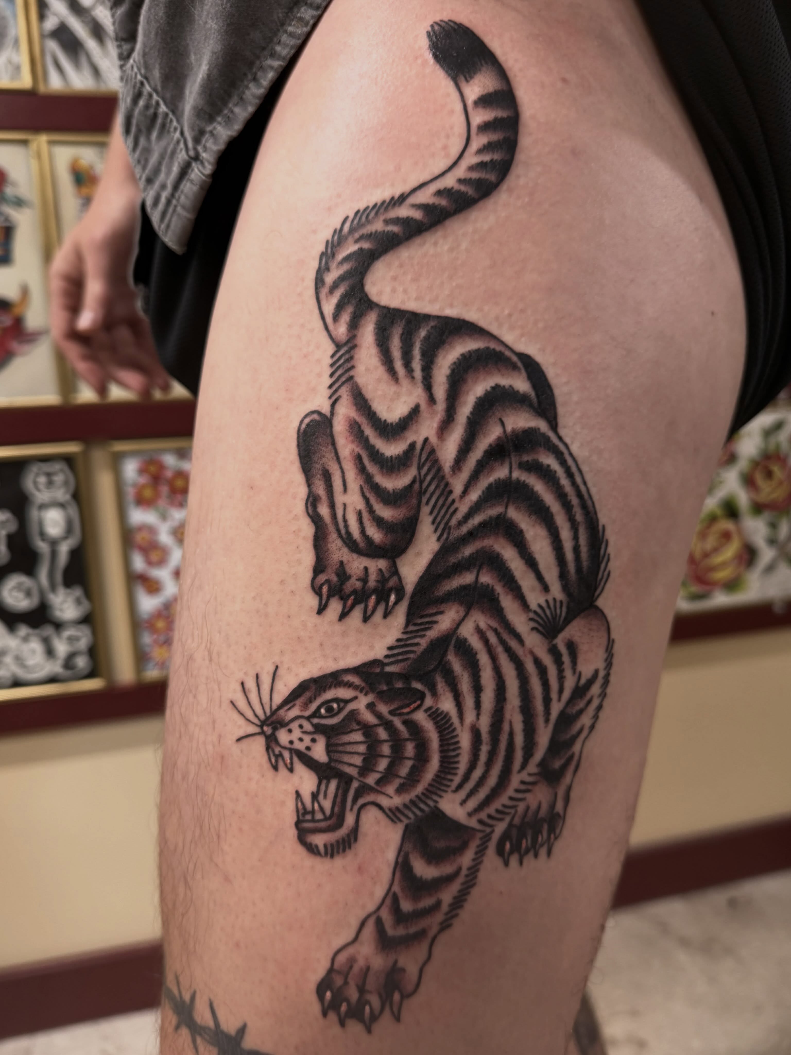 Tiger American traditional tattoo on the thigh by Gerald Bellmore