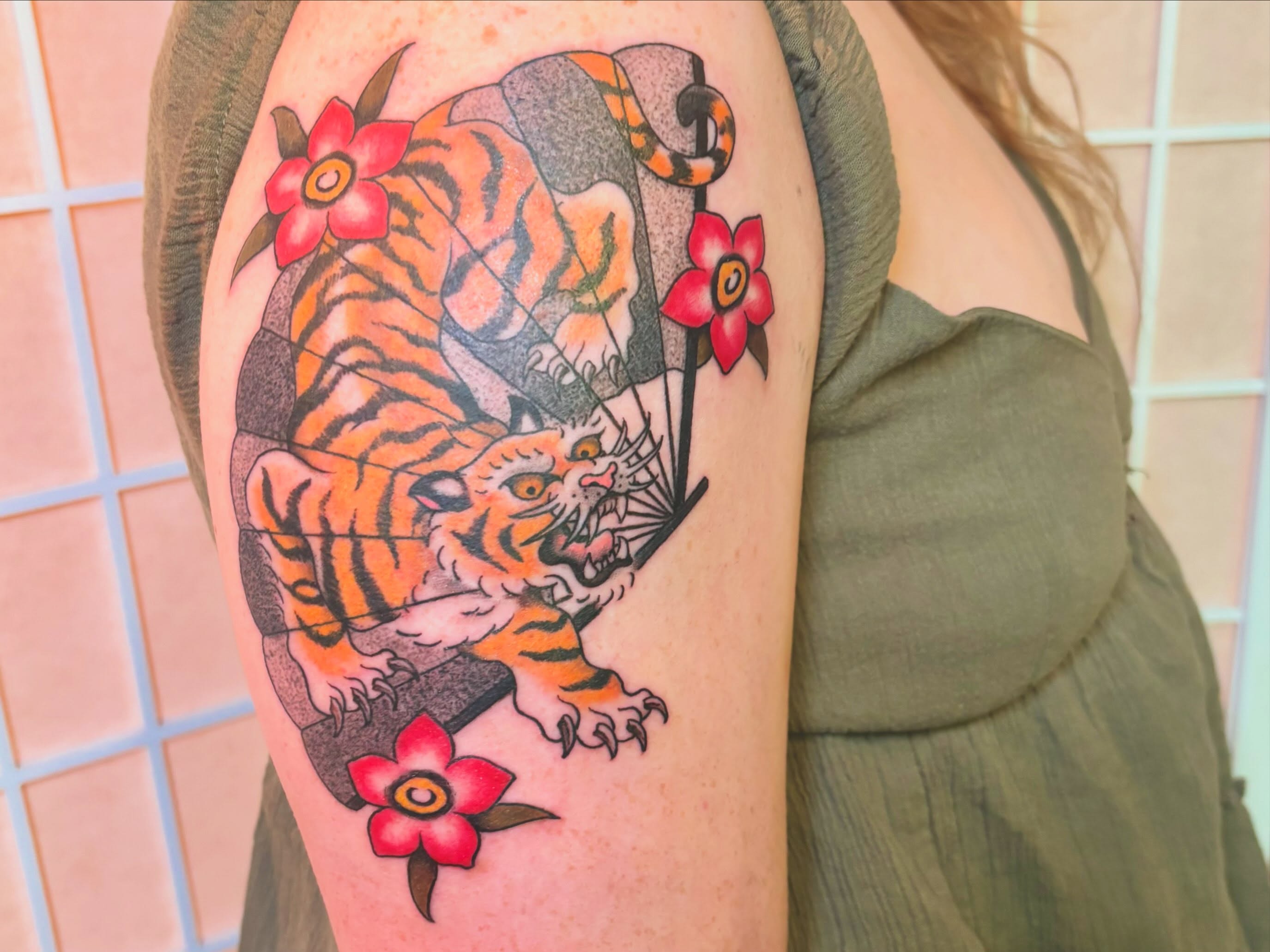 Tiger and flowers American traditional tattoo on the shoulder by Leah Leinani