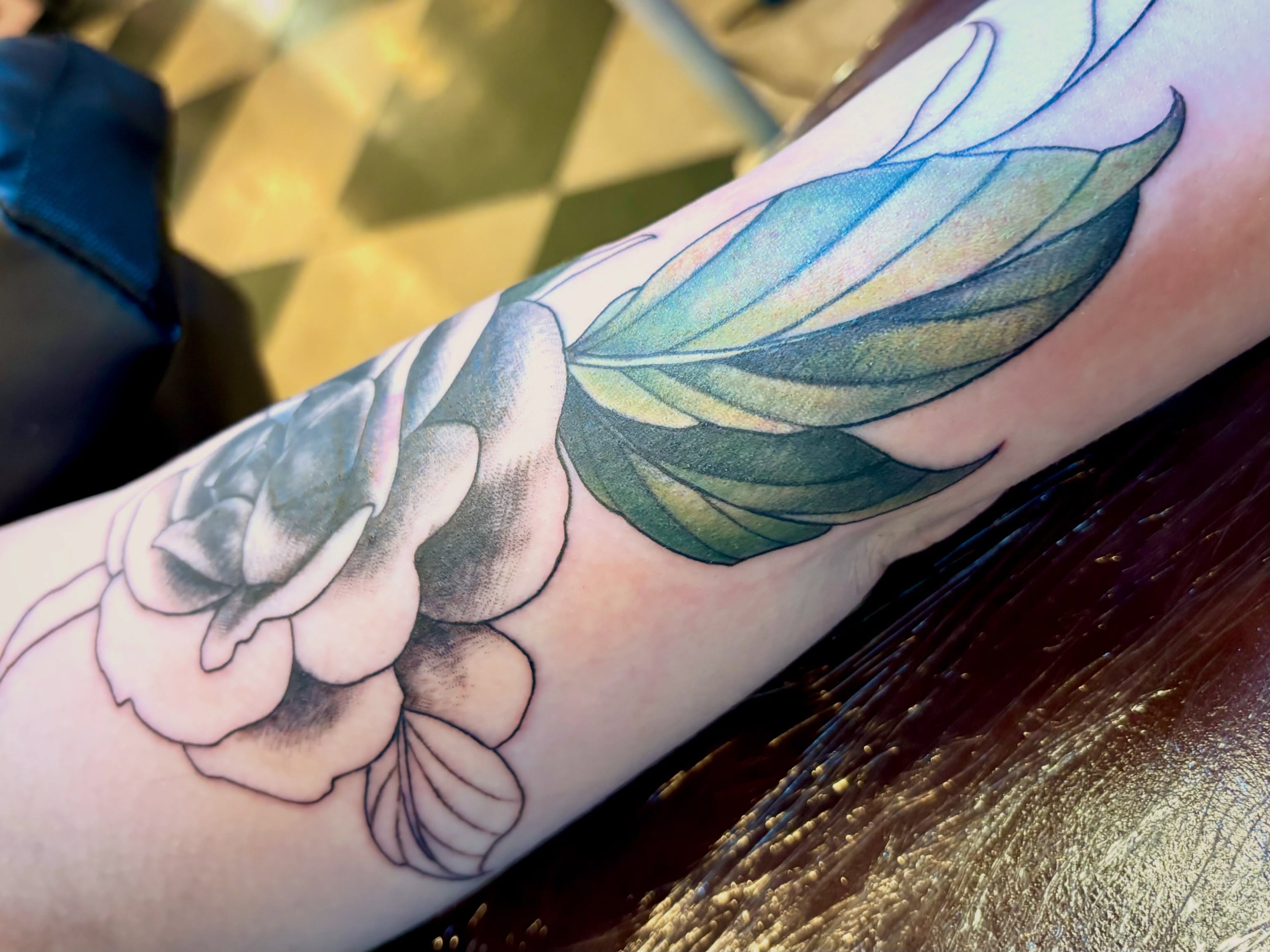Flower with wings realism tattoo on the forearm by Leah Leinani