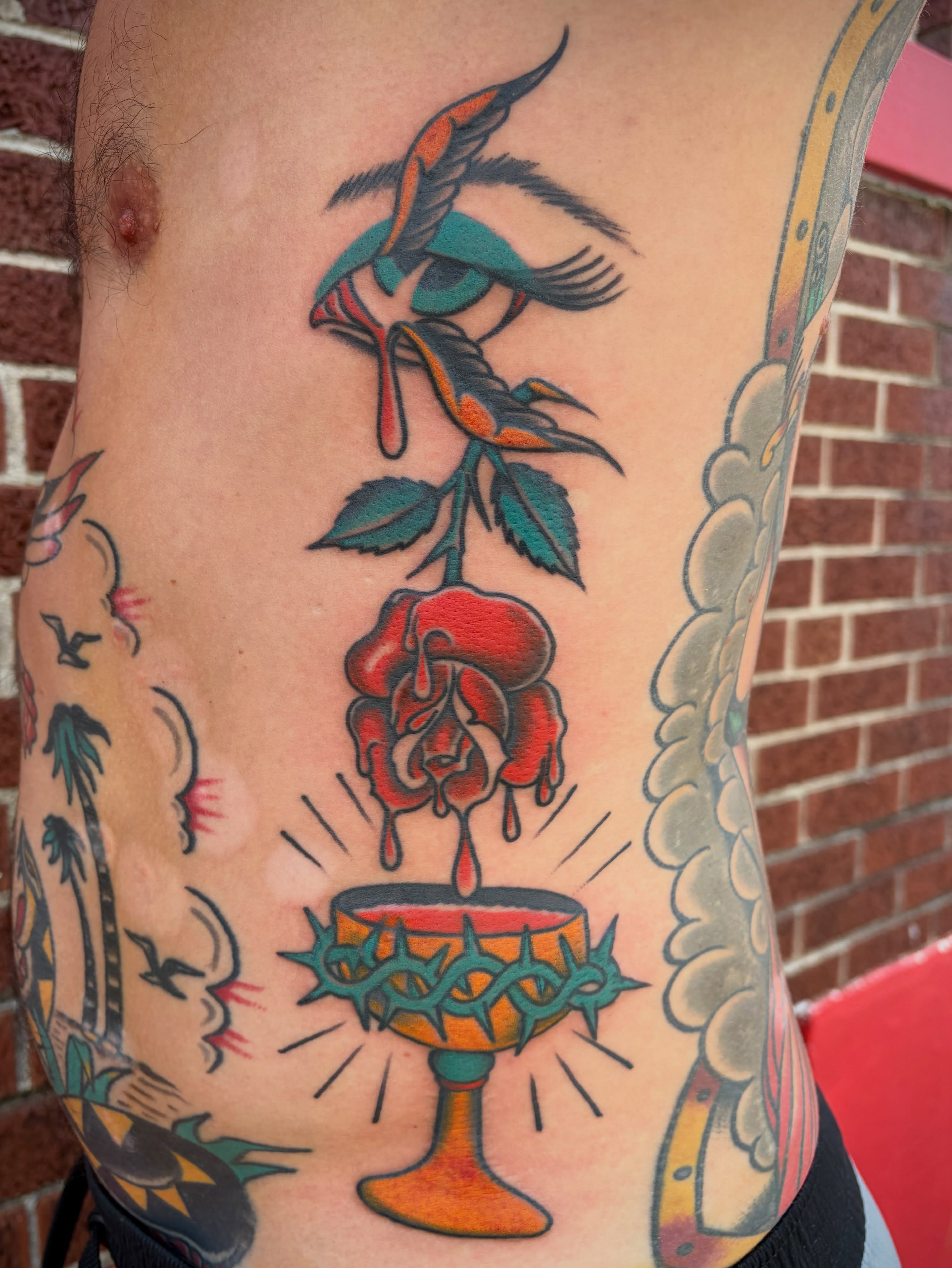 Rose and chalice American traditional tattoo on the ribs by Micheal McGlinchey