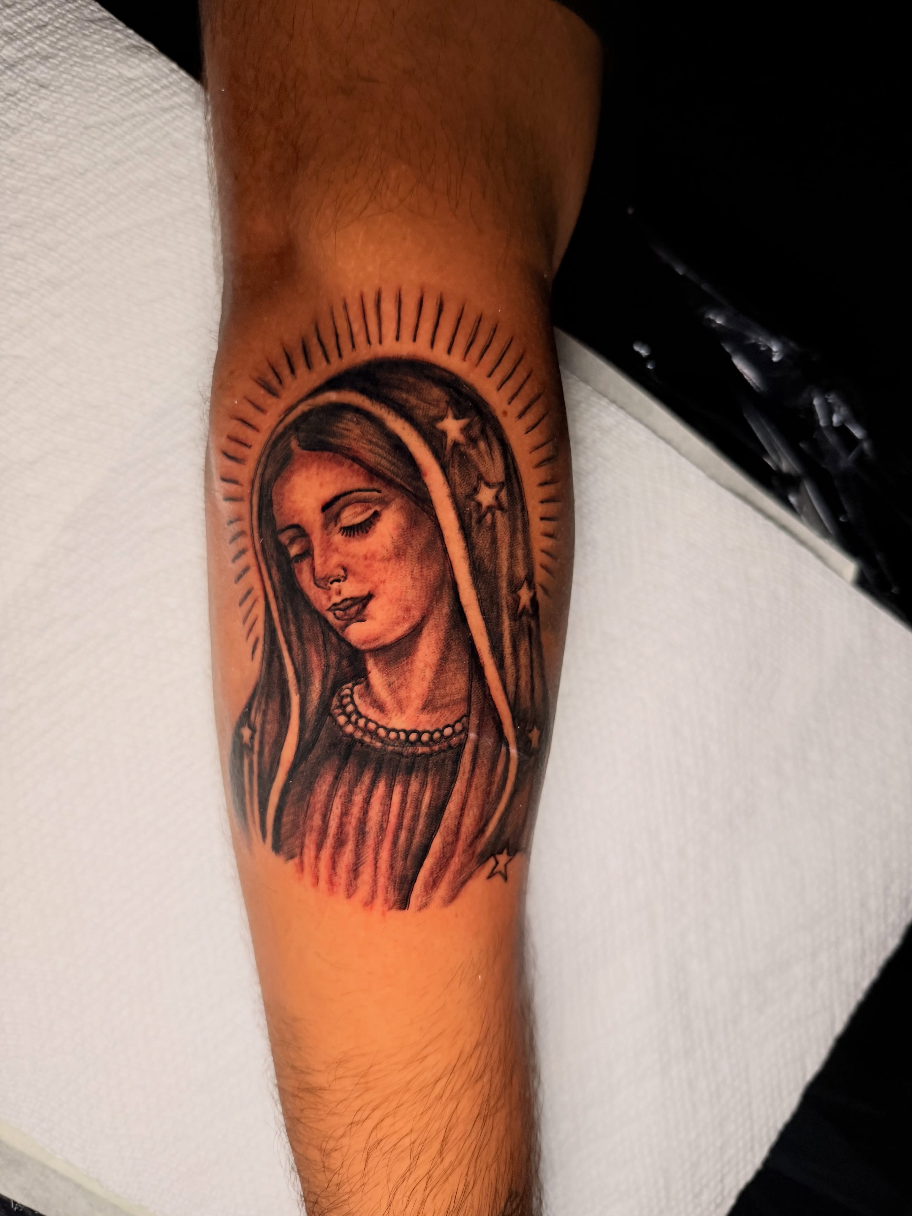Religious figure realism tattoo on the forearm by Junior Sanchez Dfw