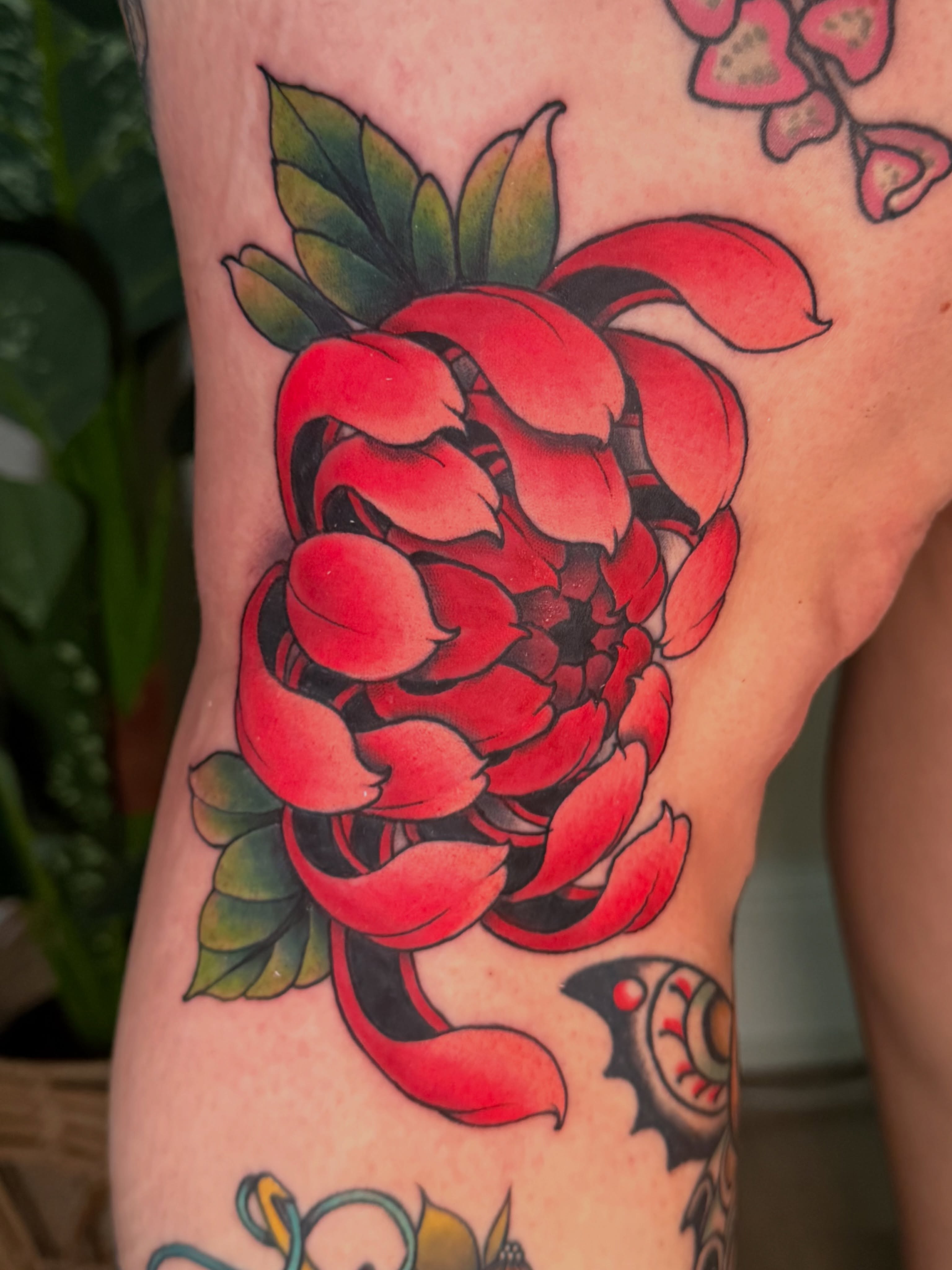 Red flower American traditional tattoo on the thigh by Chiah