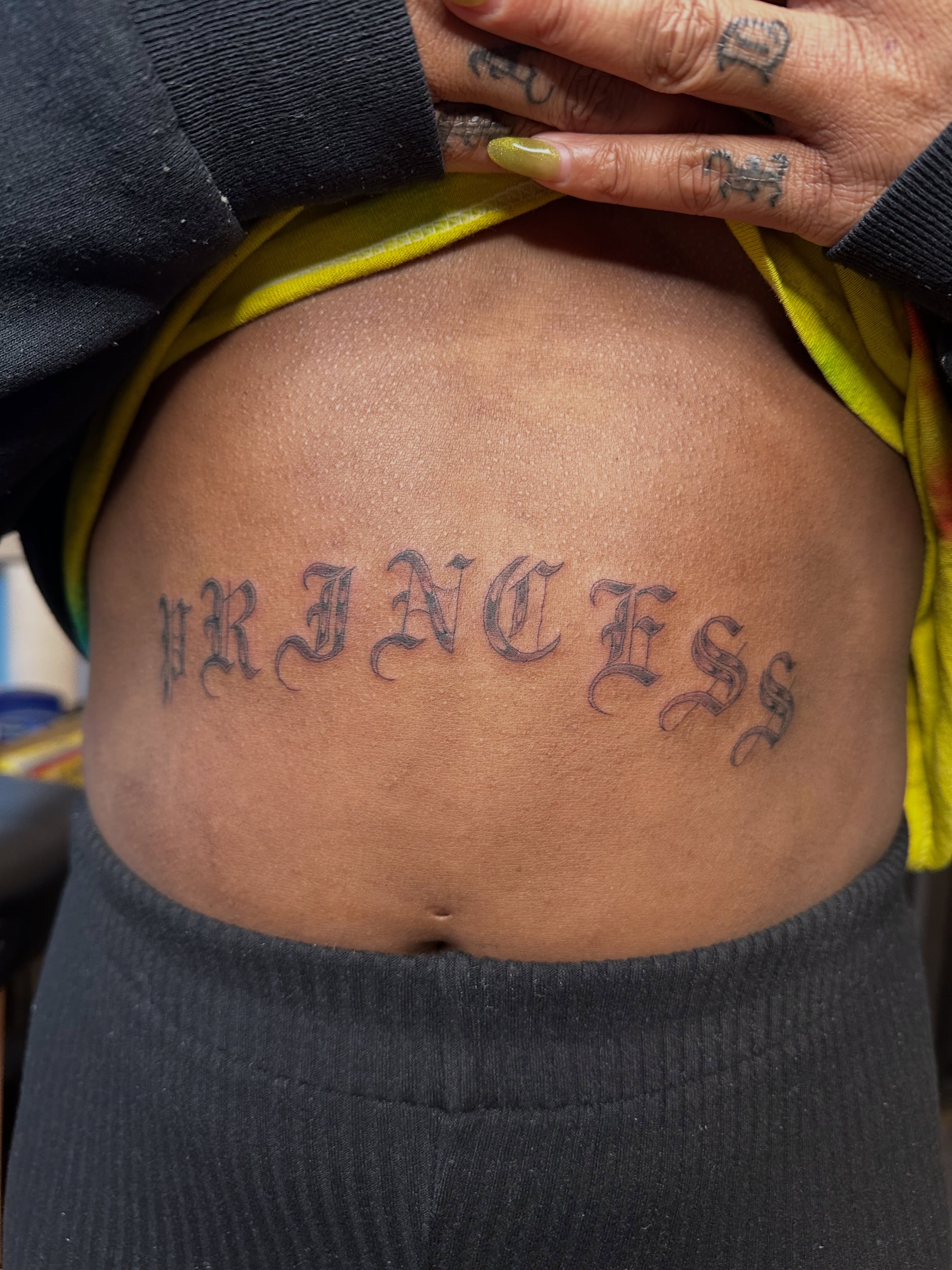 PRINCESS lettering script tattoo on the torso by christina diaz