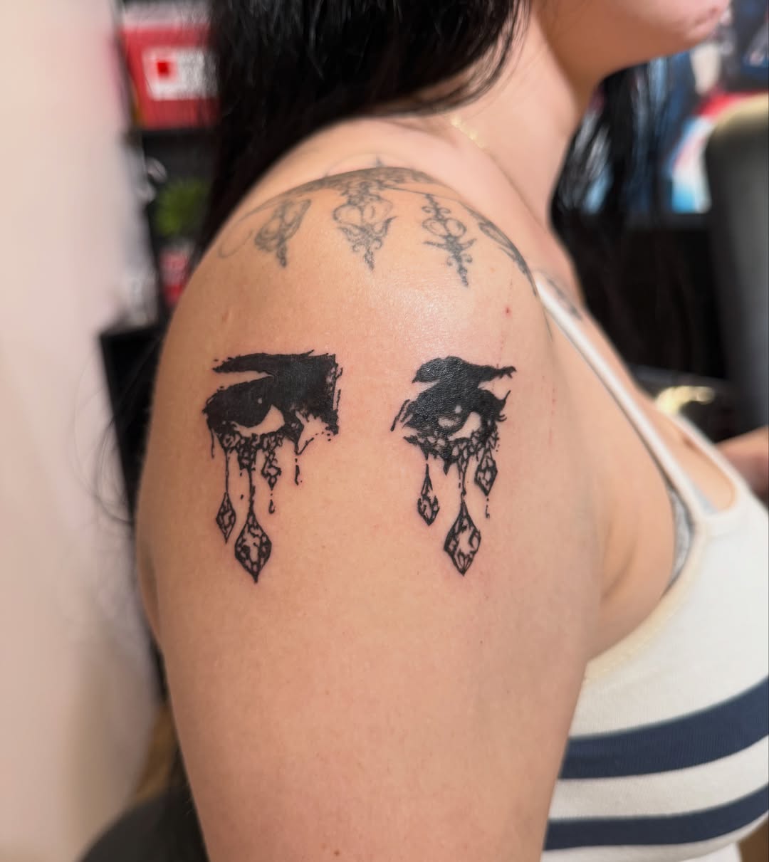 Tears black and grey tattoo on the shoulder by Lindsey