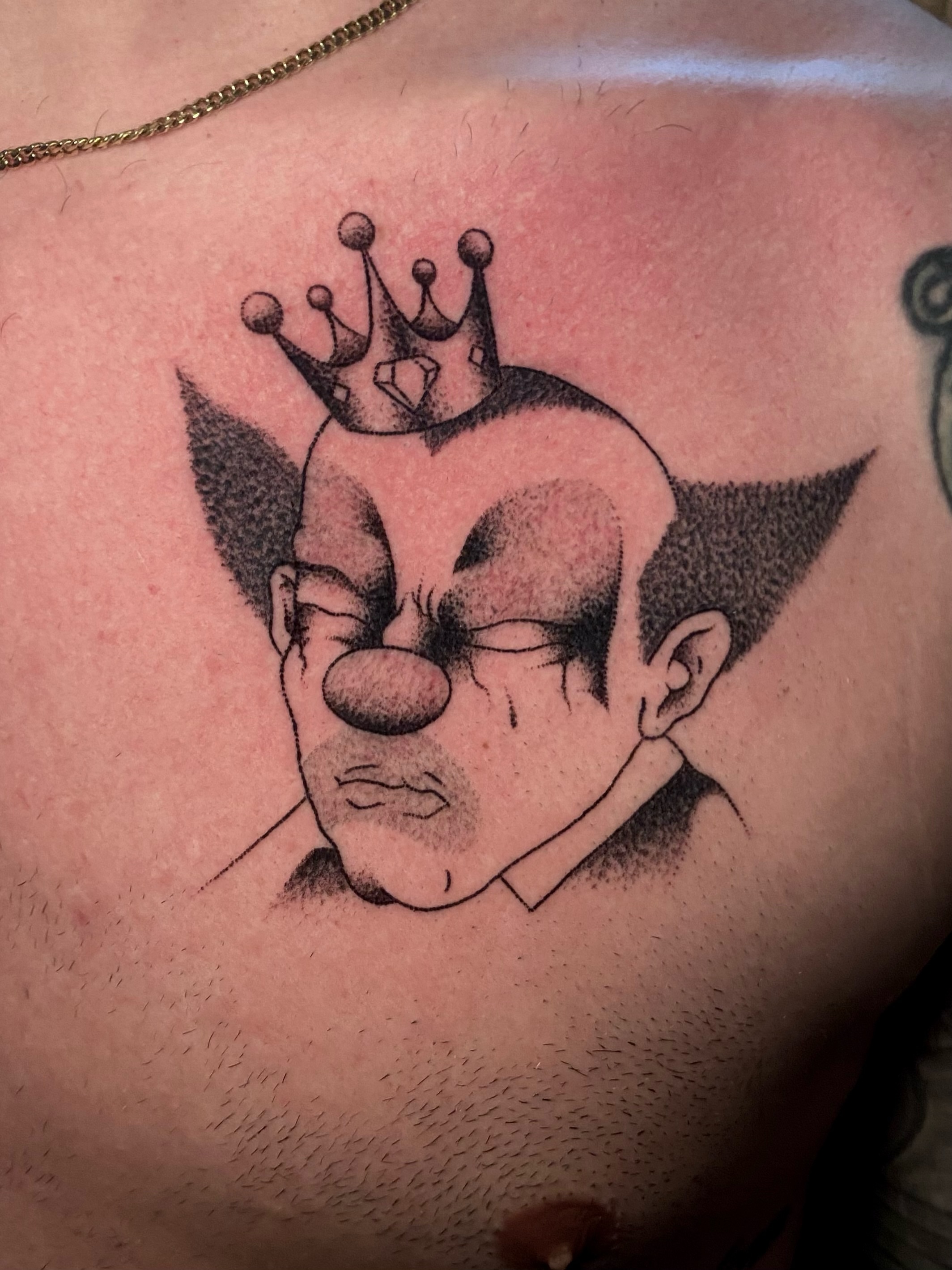 Clown with crown dotwork tattoo on the chest by Daniel Diego