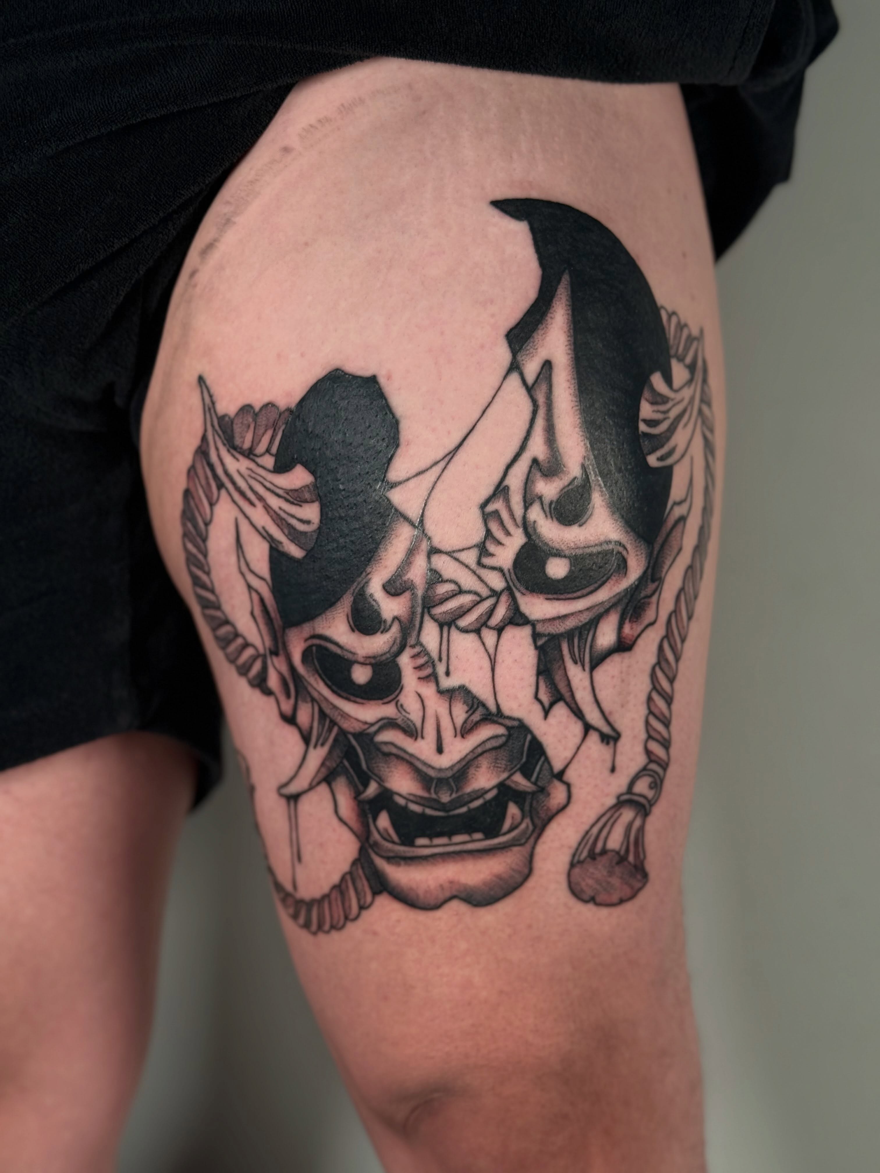 Mask black and grey tattoo on the thigh by šianca٠࣪ā