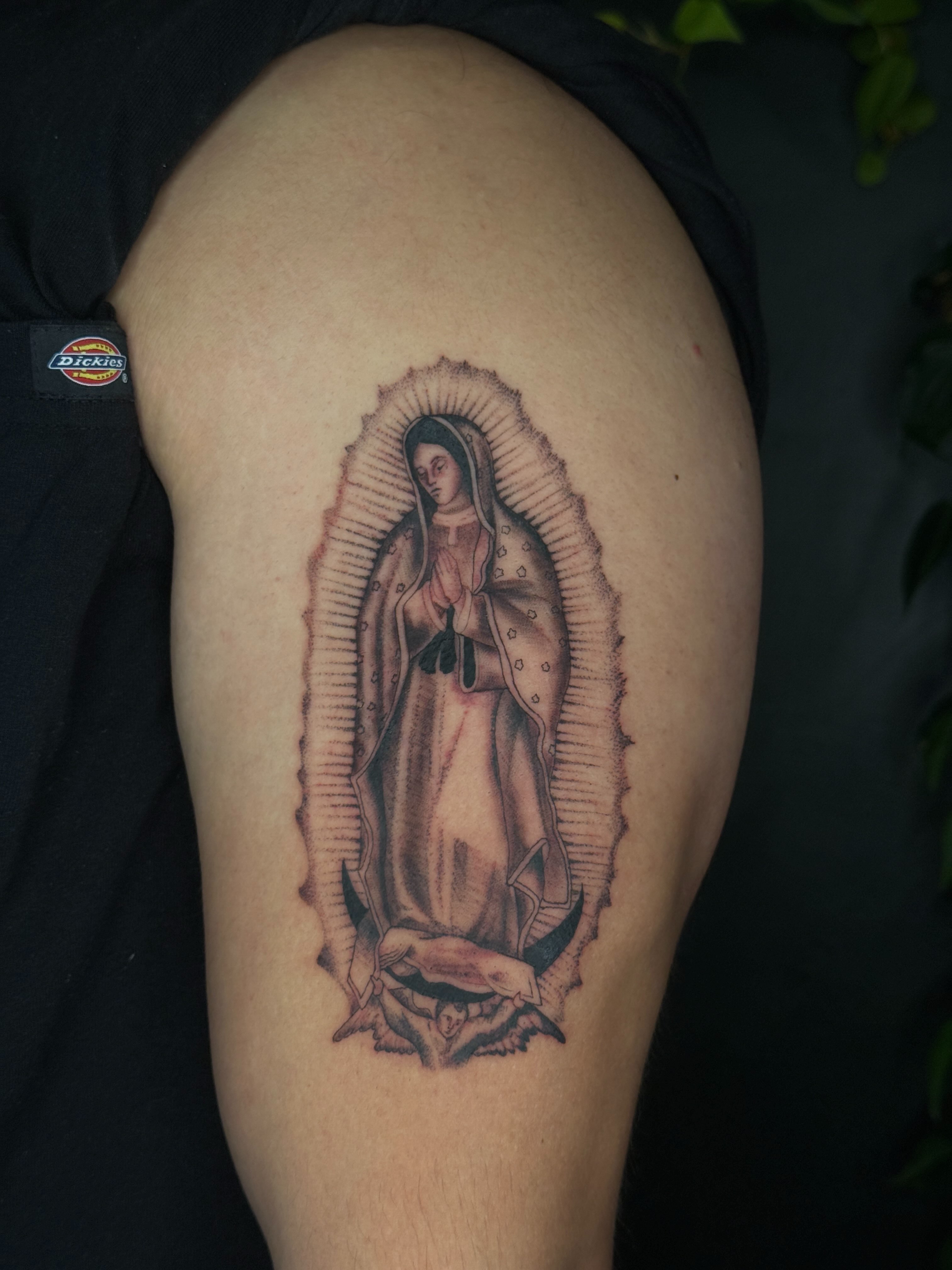 Our Lady of Guadalupe black and grey tattoo on the upper arm by šianca٠࣪ā