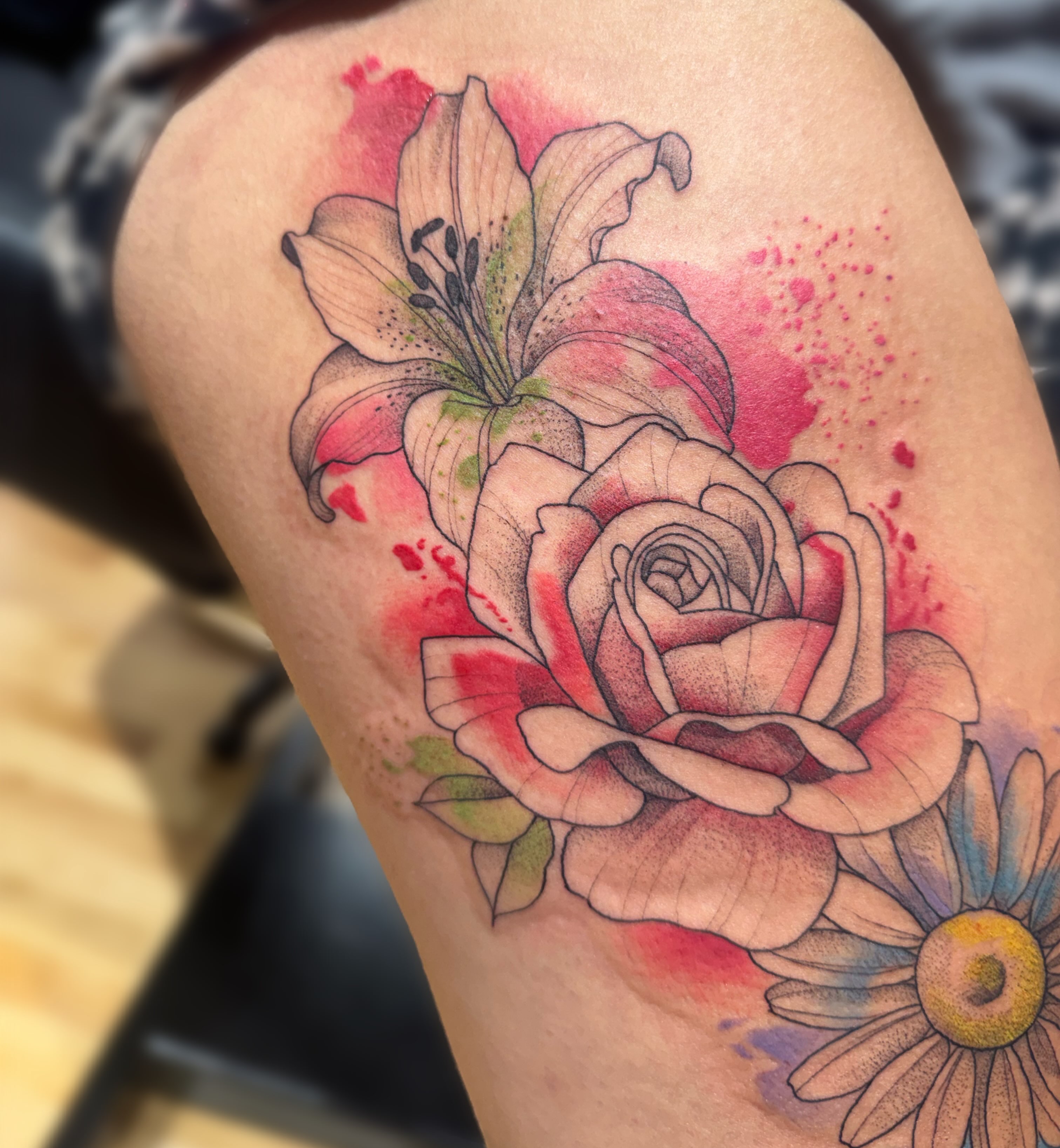 Floral arrangement watercolor tattoo on the thigh by Elly Bordwell