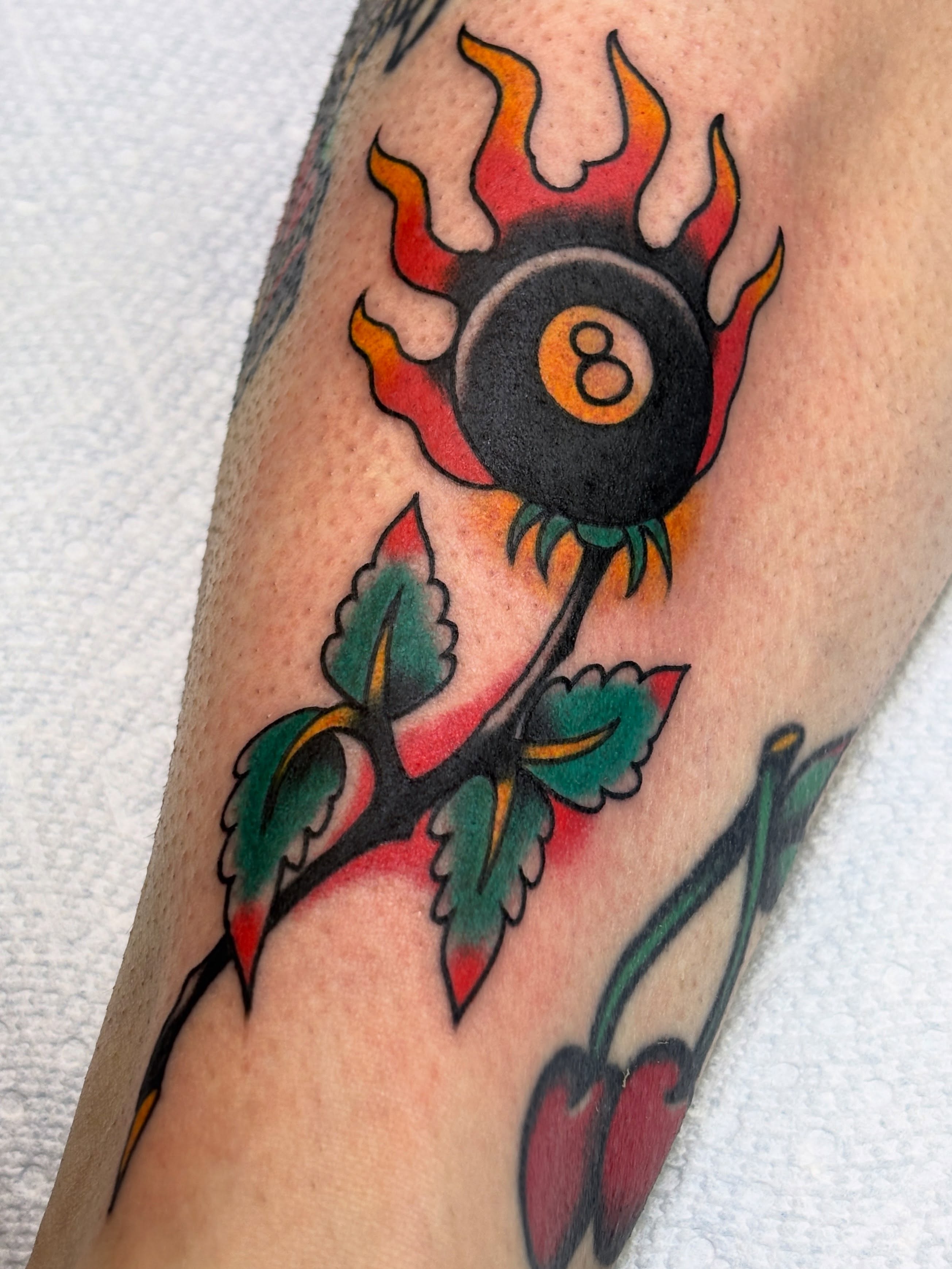 8-ball with flames American traditional tattoo on the forearm by Mike DiCicco