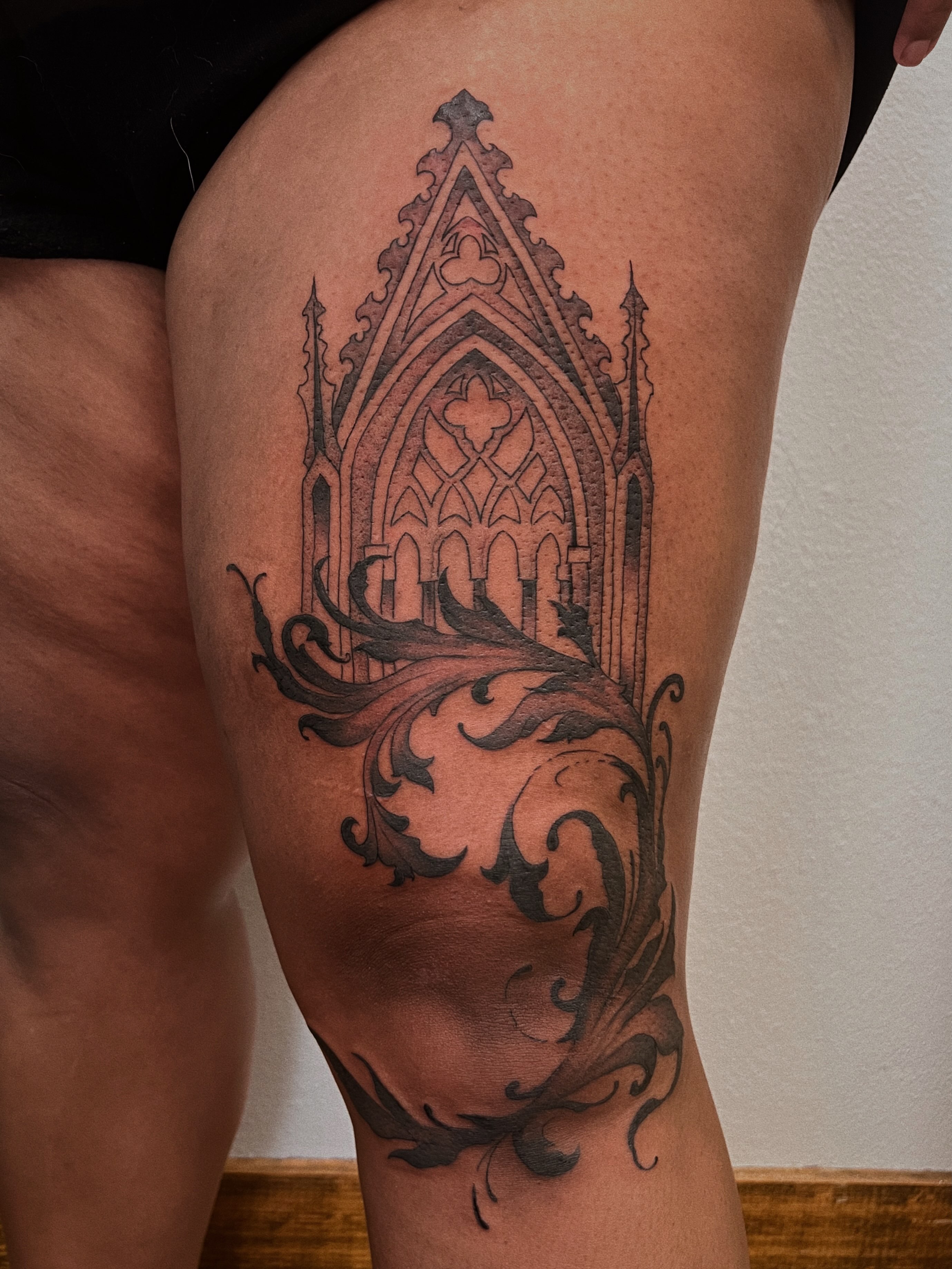 Gothic cathedral black and grey tattoo on the thigh by Rebecca Kern Tattoos