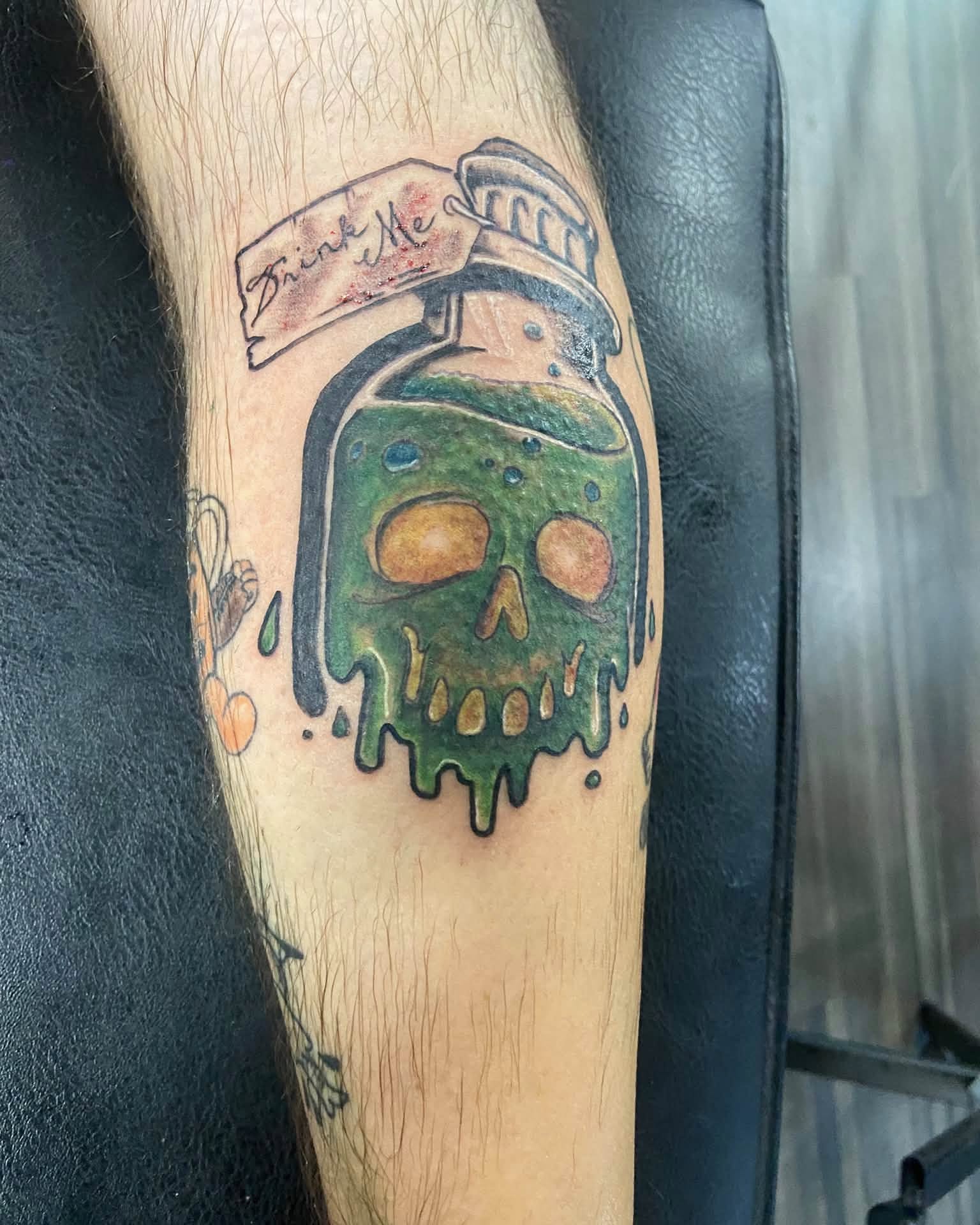 Poison bottle with skull realism tattoo on the forearm by Mike Berry