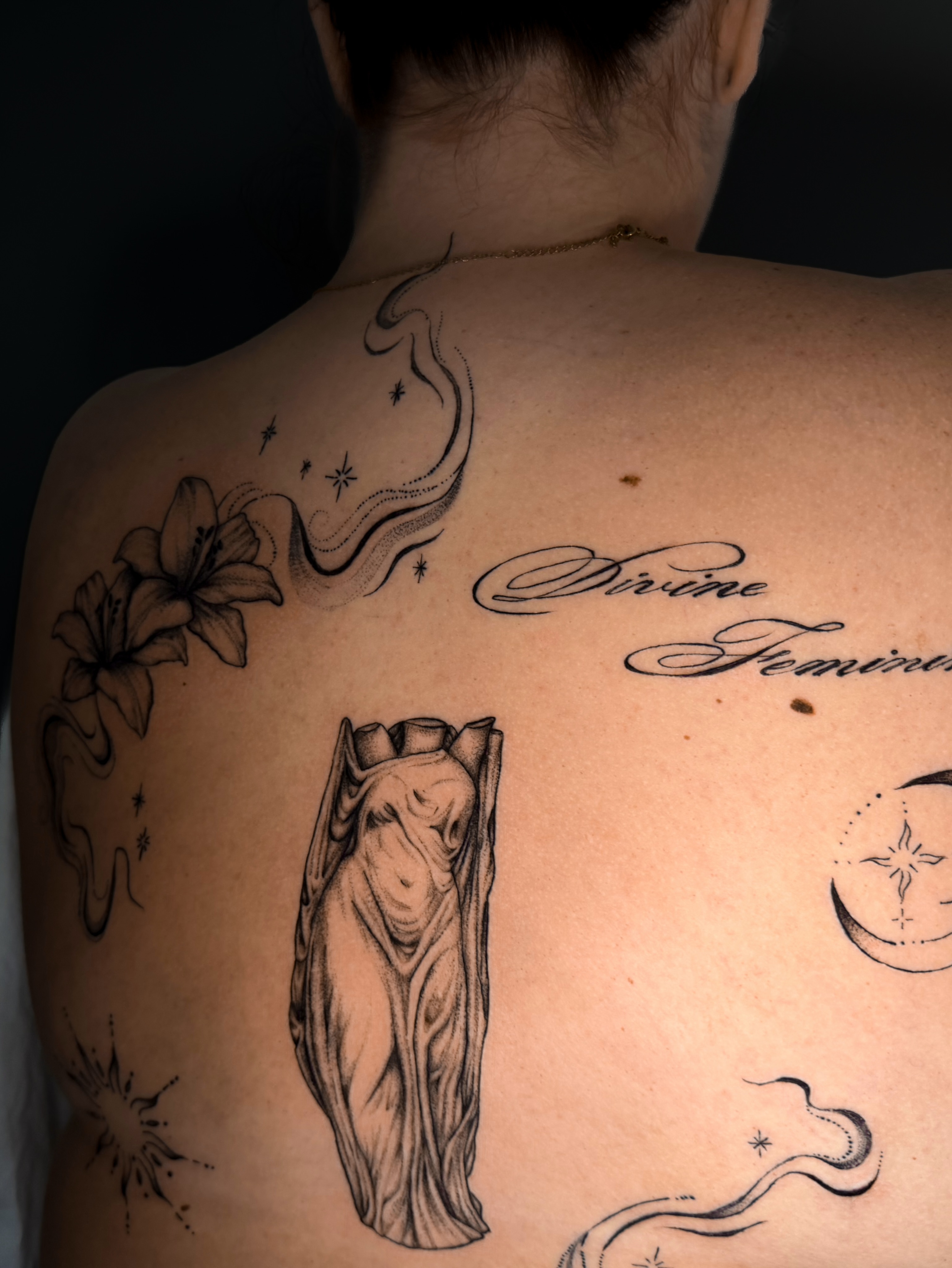 Statue realism tattoo on the back by Kam Mills