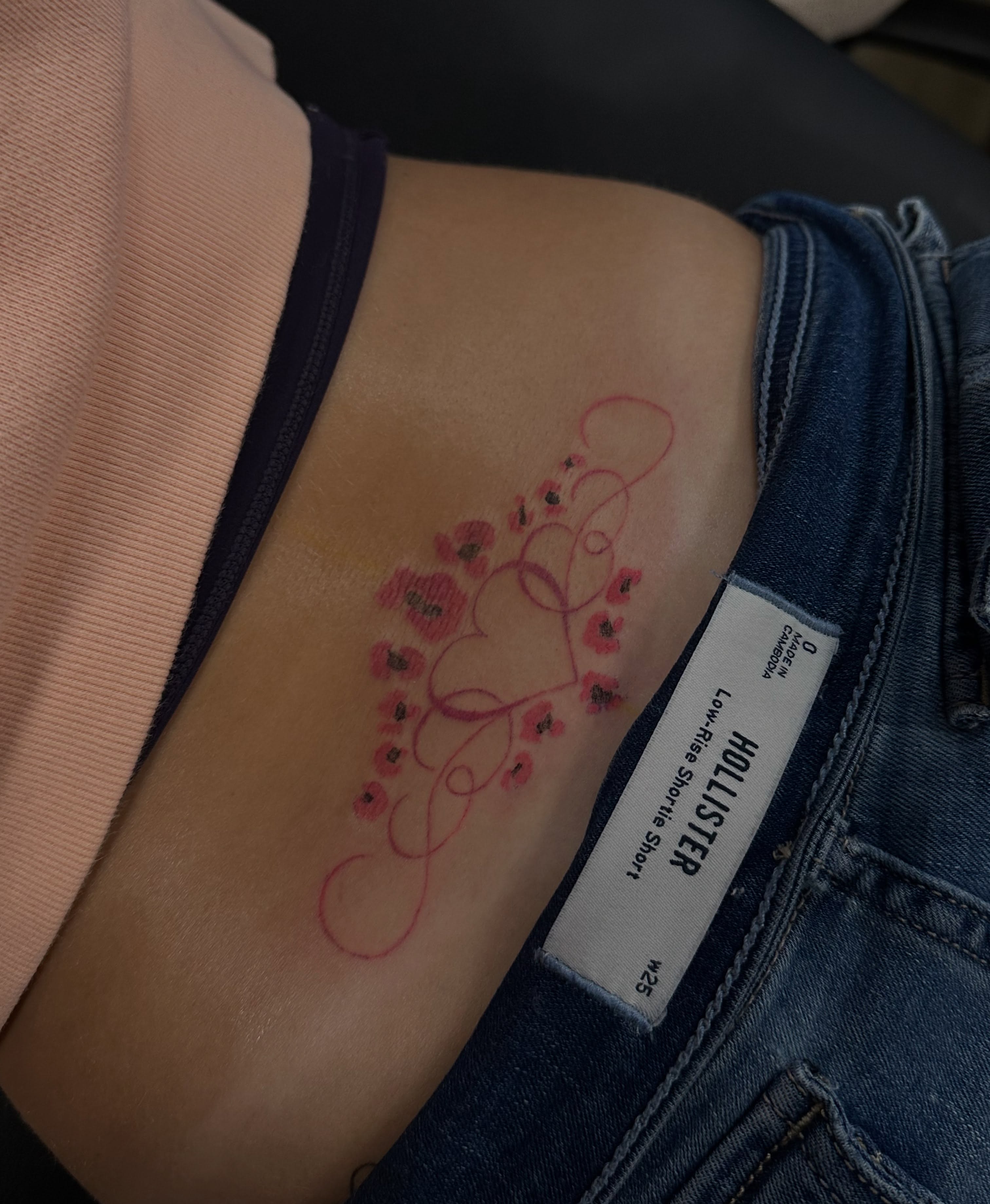 Flowers fine line tattoo on the thigh by Bell