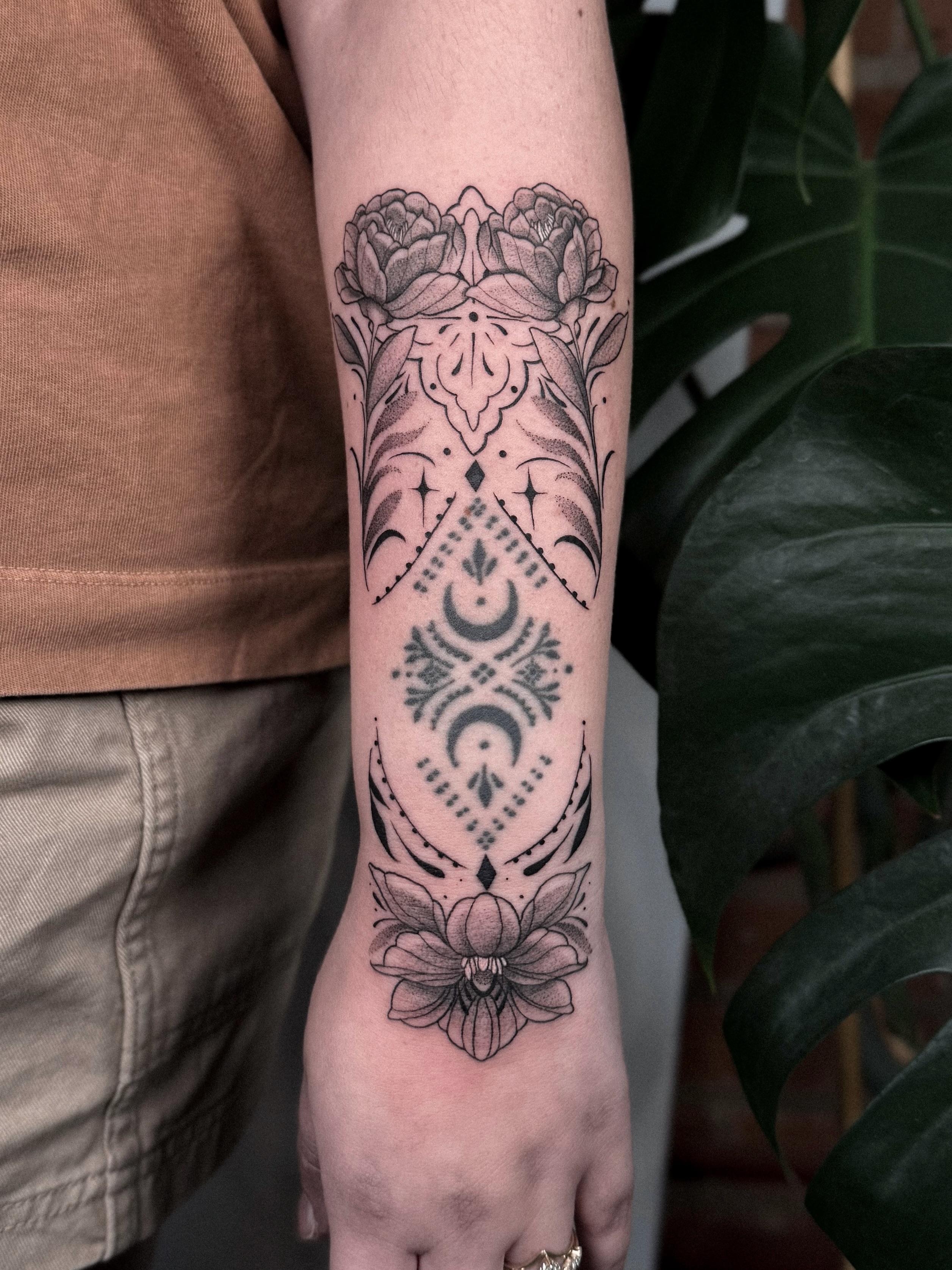 Floral and celestial design dotwork tattoo on the forearm by Jessica Bloom