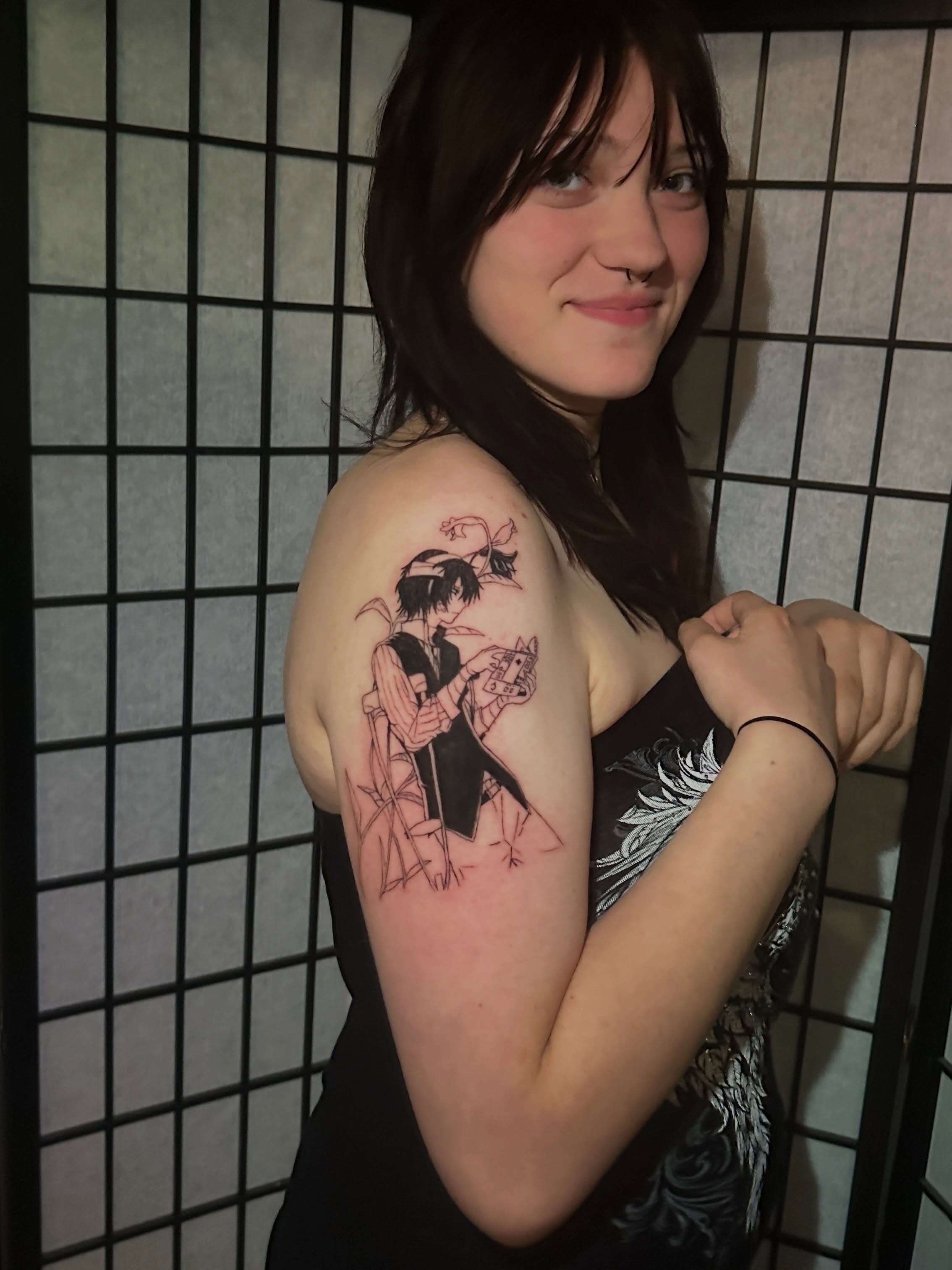Anime character anime tattoo on the upper arm by Chris Whittaker Tattoo Artist