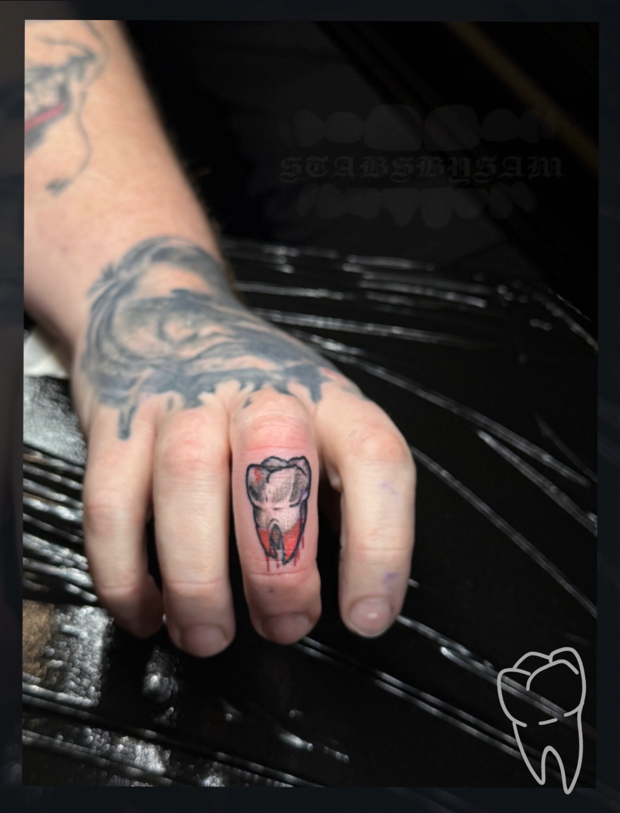 Tooth realism tattoo on the hand by licensed charlotte tattoo artist