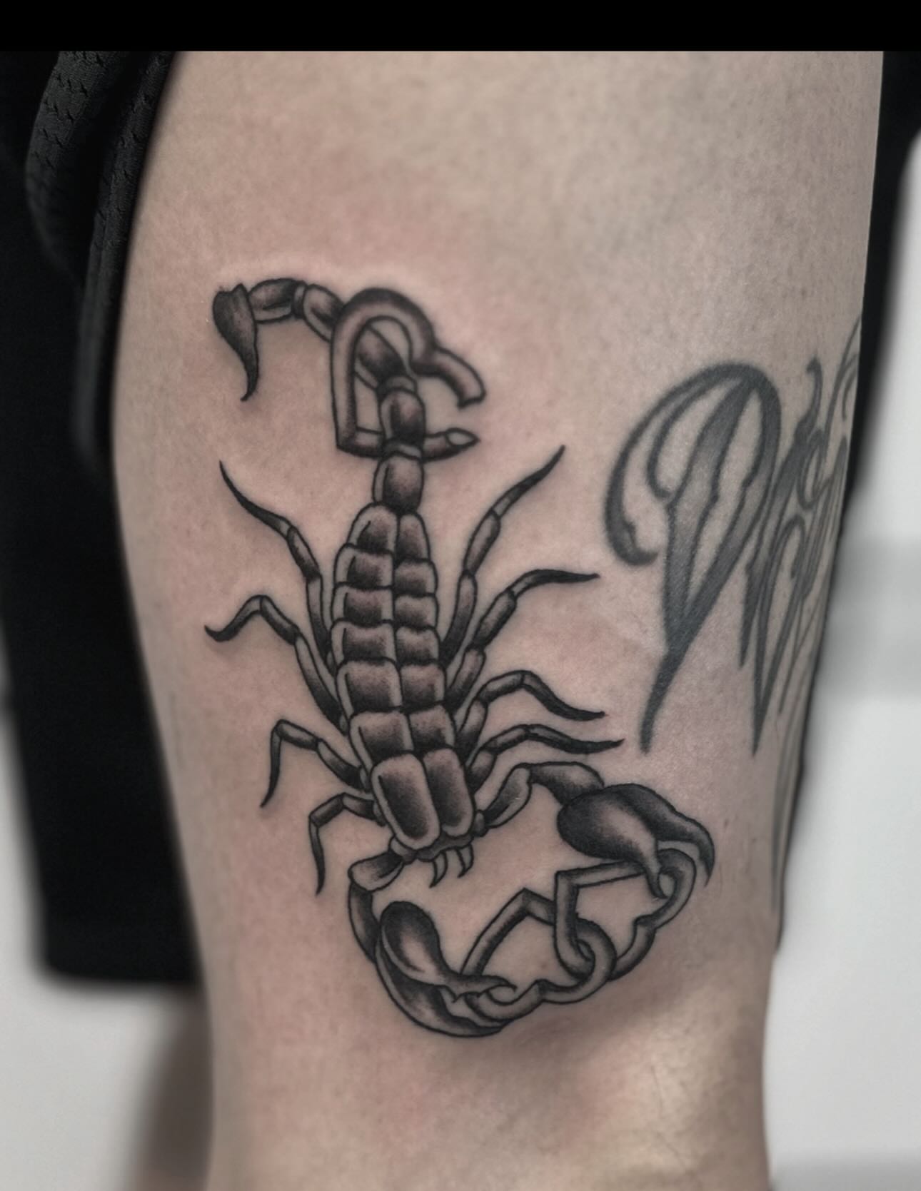Scorpion black and grey tattoo on the thigh by Micah Norman, San Francisco, California