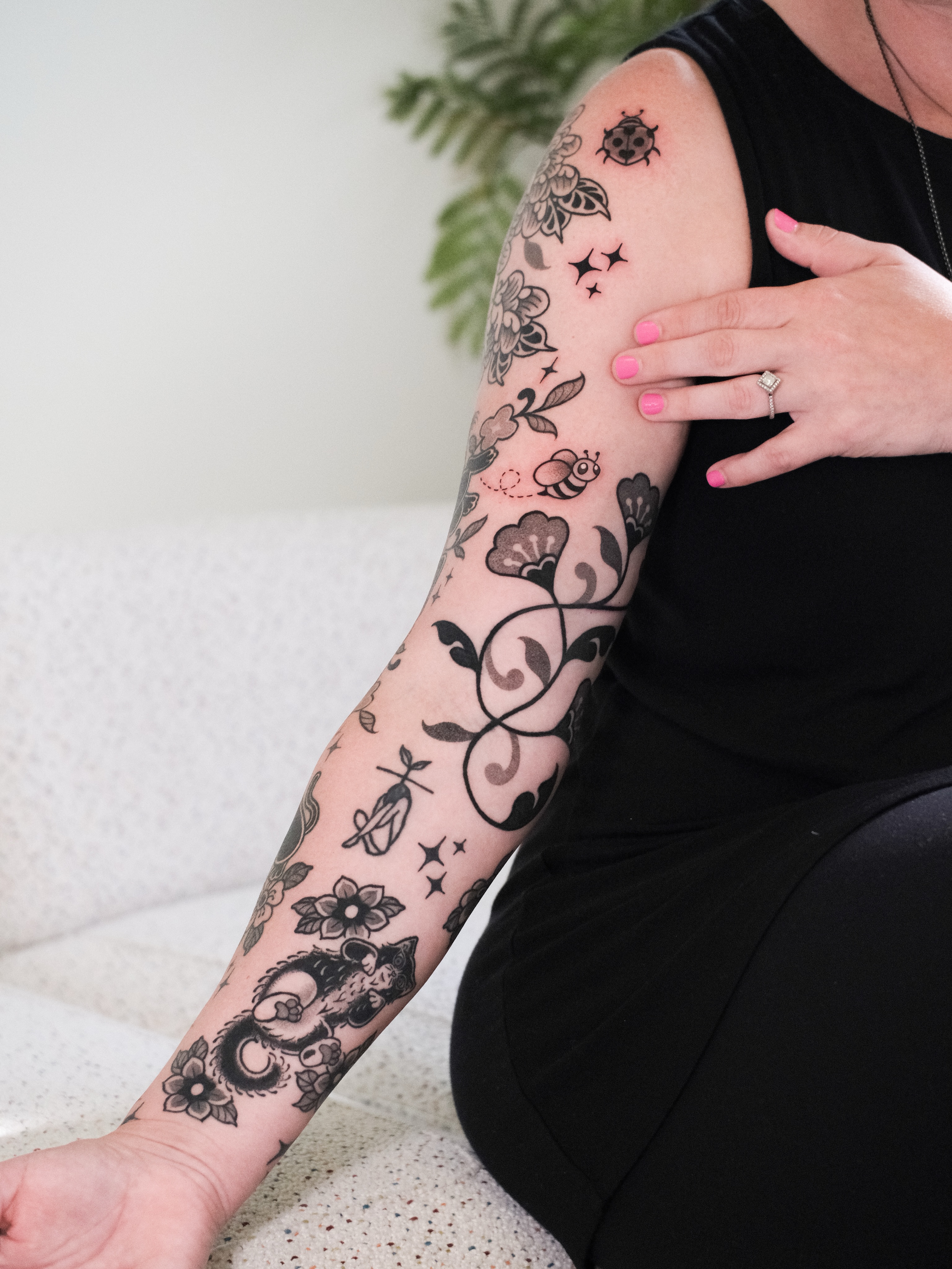 Floral and bee black and grey tattoo on the forearm by seattle tattoo artist