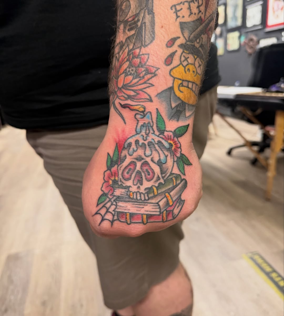 Skull with flowers American traditional tattoo on the forearm by Kane L, Albuquerque, New Mexico