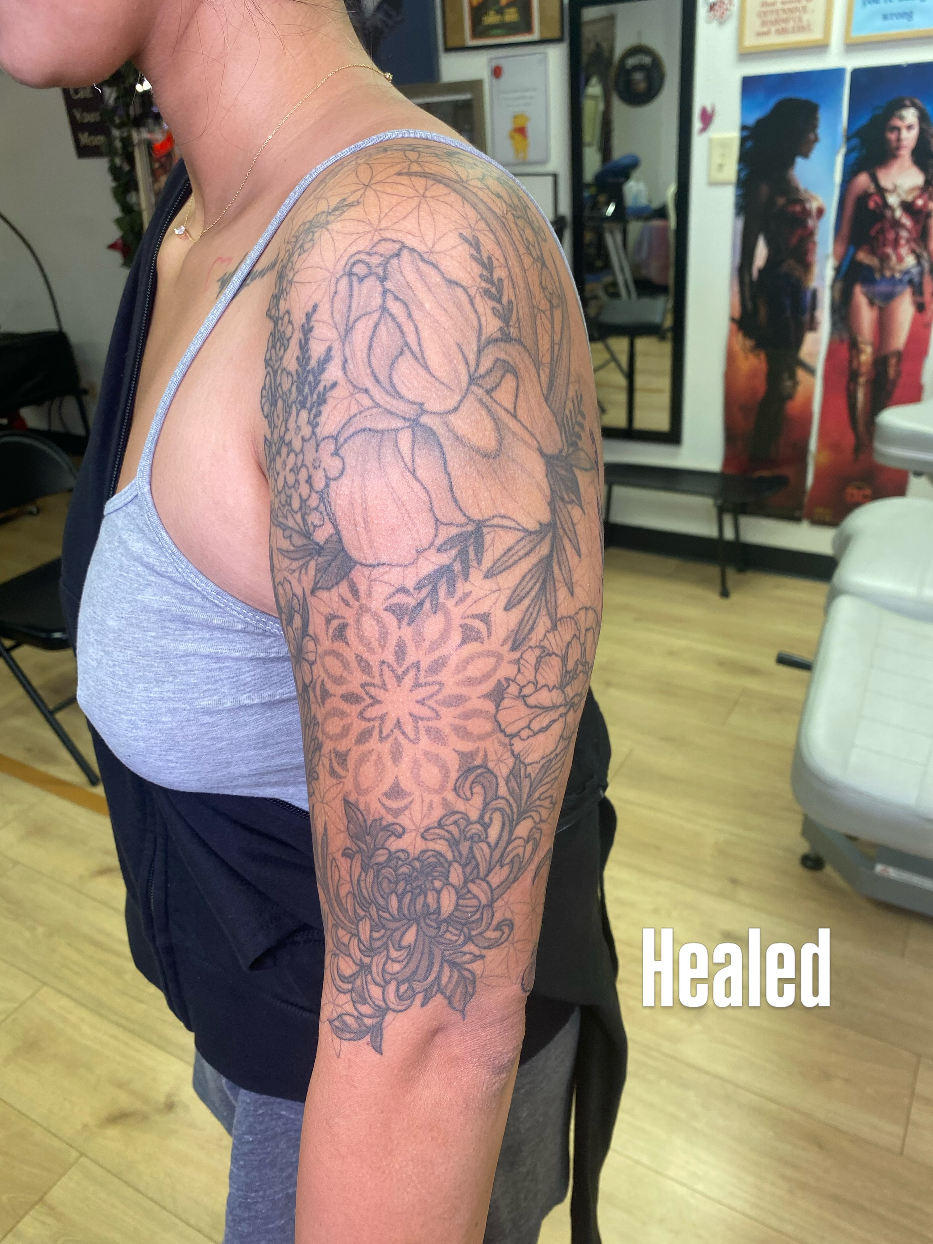 Floral arrangement ornamental tattoo on the upper arm by Katie Leeper