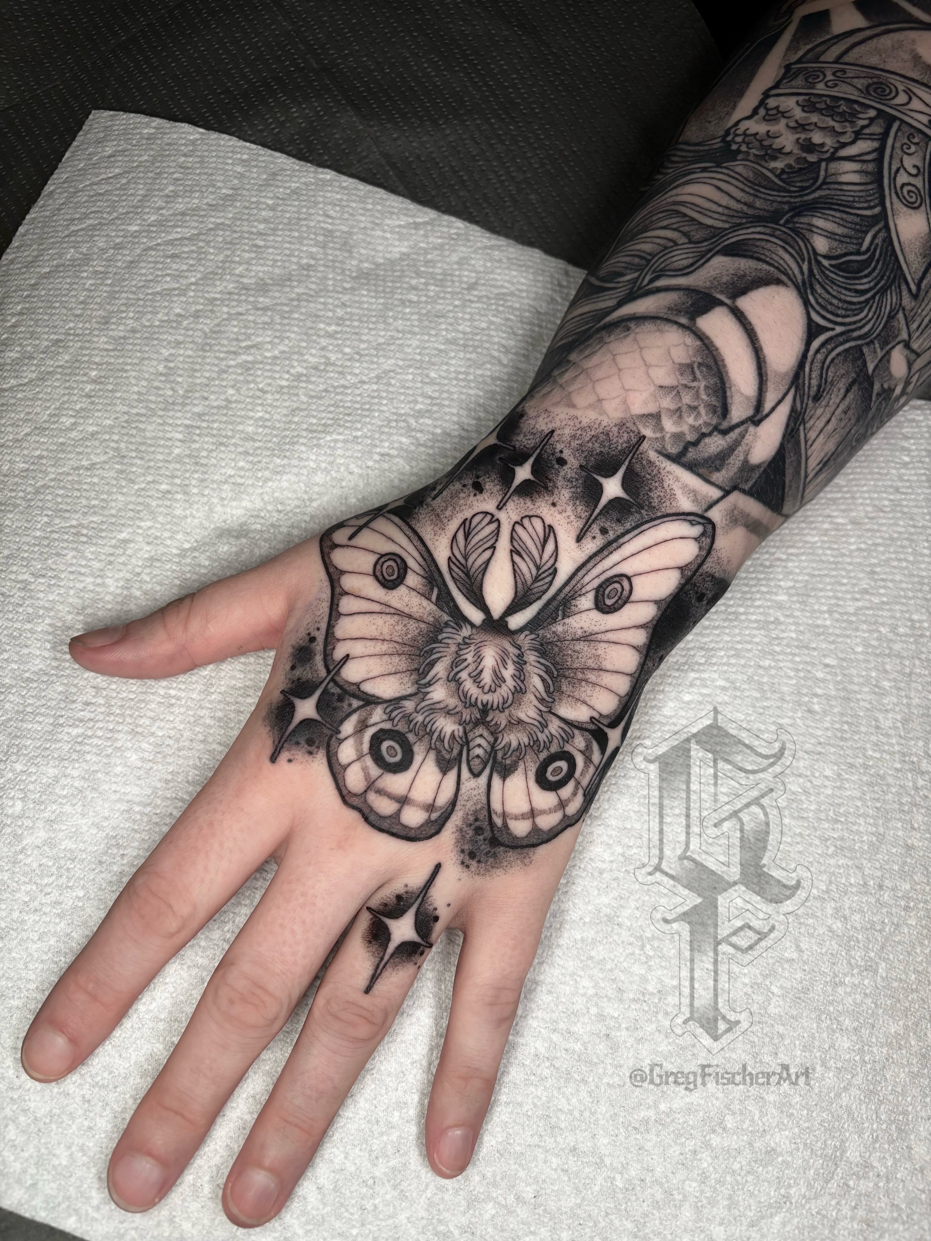 Butterfly black and grey tattoo on the hand by Greg Fischer