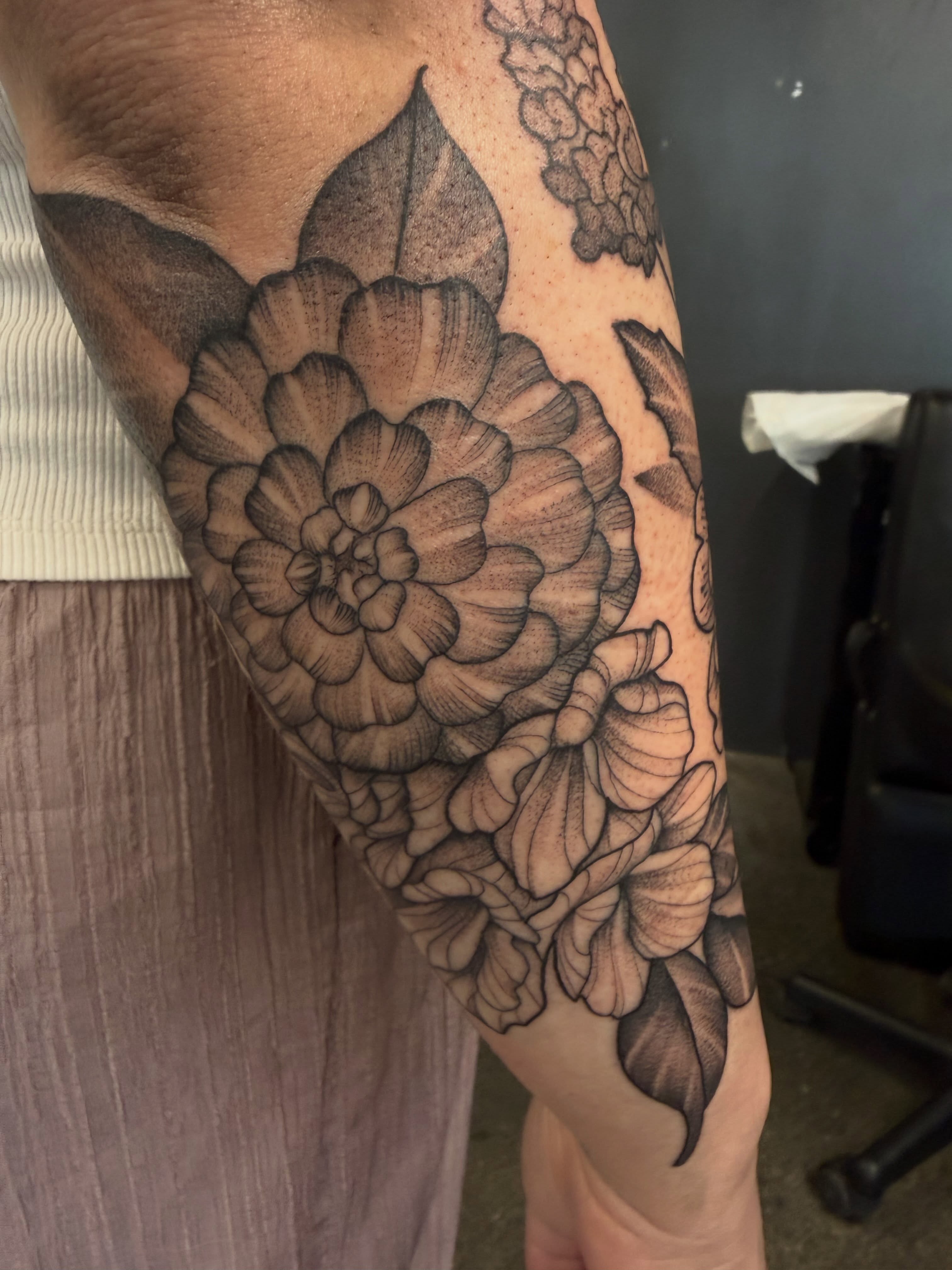 Flower black and grey tattoo on the forearm by Will Campbell