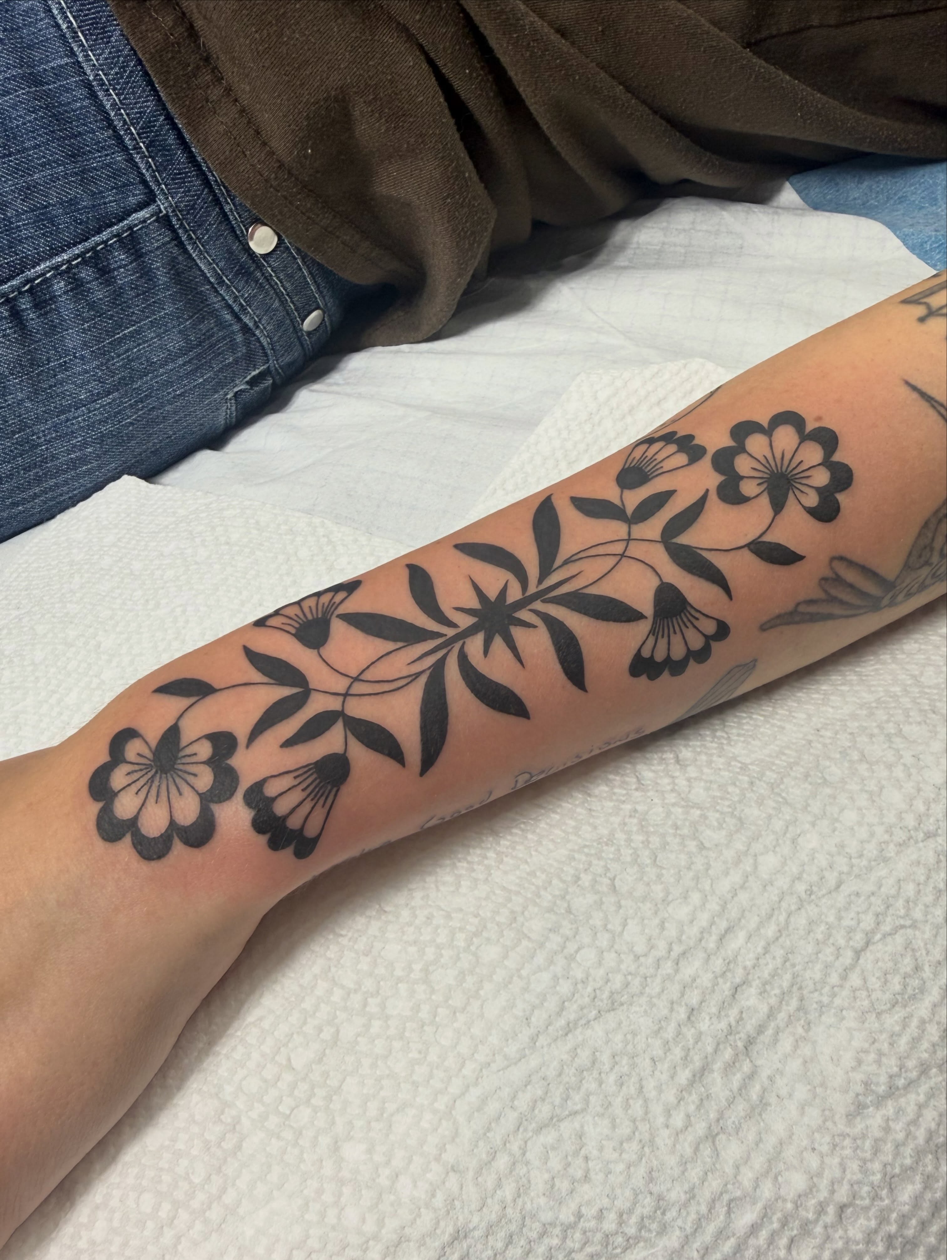 Floral pattern black and grey tattoo on the forearm by Maddie Jo DeYoung