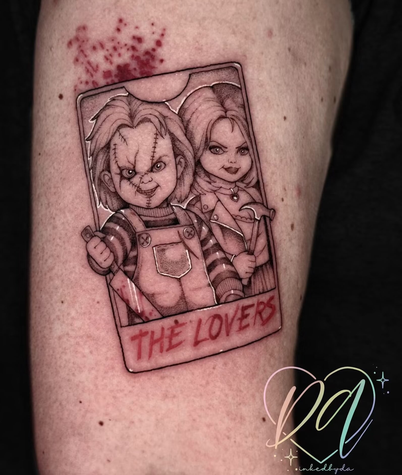 Chucky and Tiffany black and grey tattoo on the forearm by Dalton Alexandria