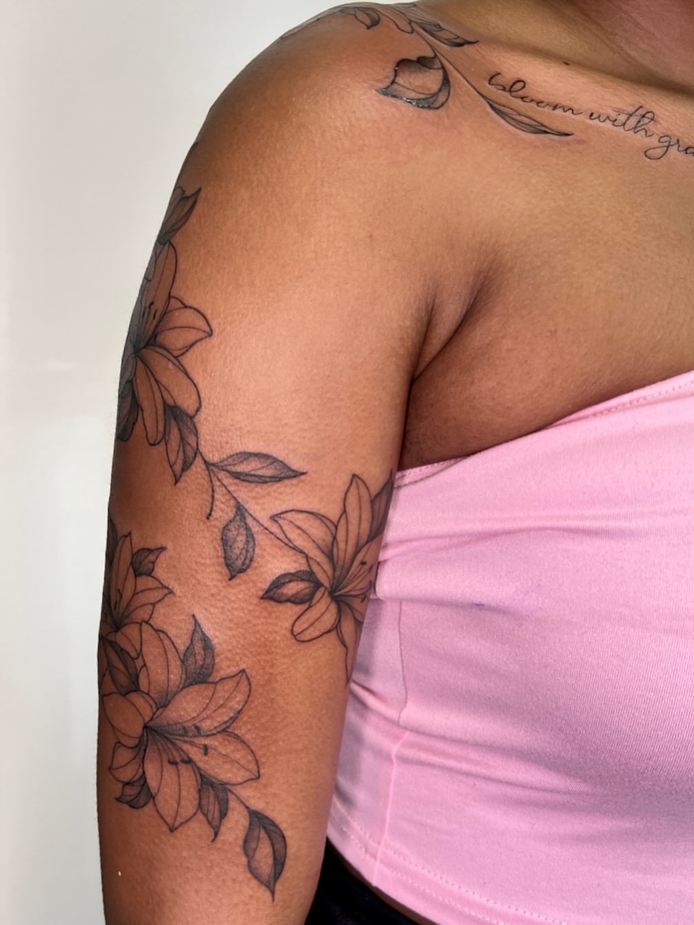 Floral arrangement black and grey tattoo on the upper arm by Presley Tattoos, Murfreesboro, Tennessee
