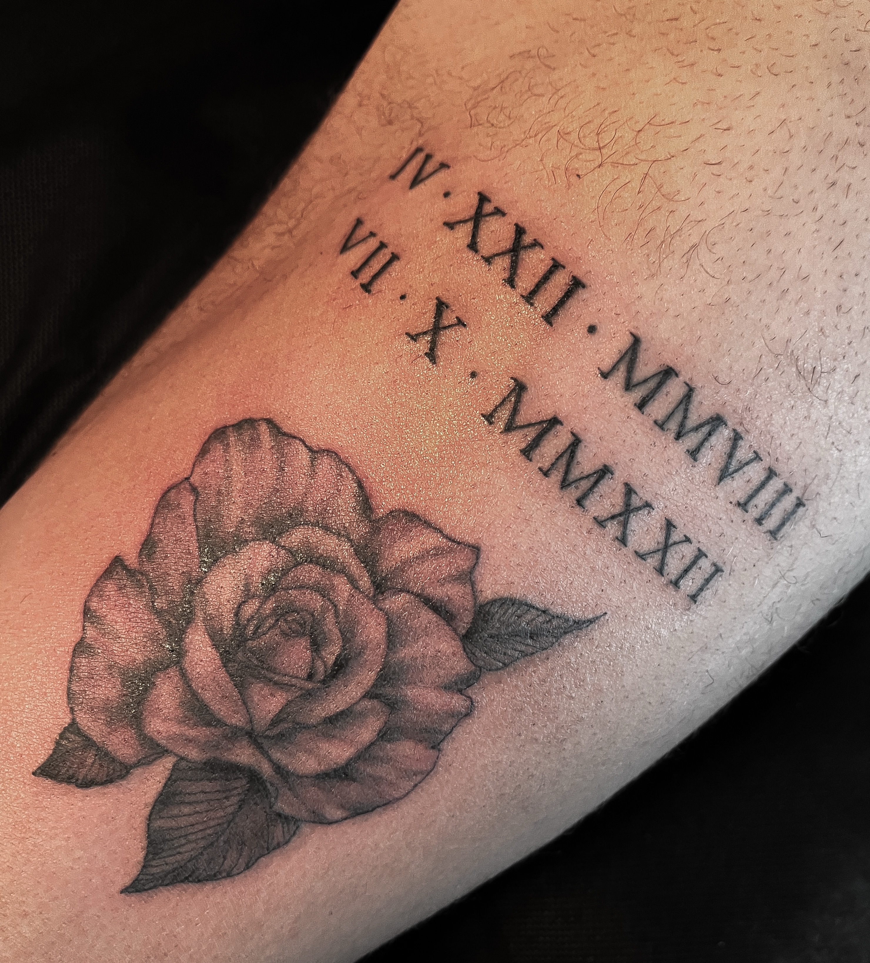 Rose black and grey tattoo on the forearm by Janelle Cuba