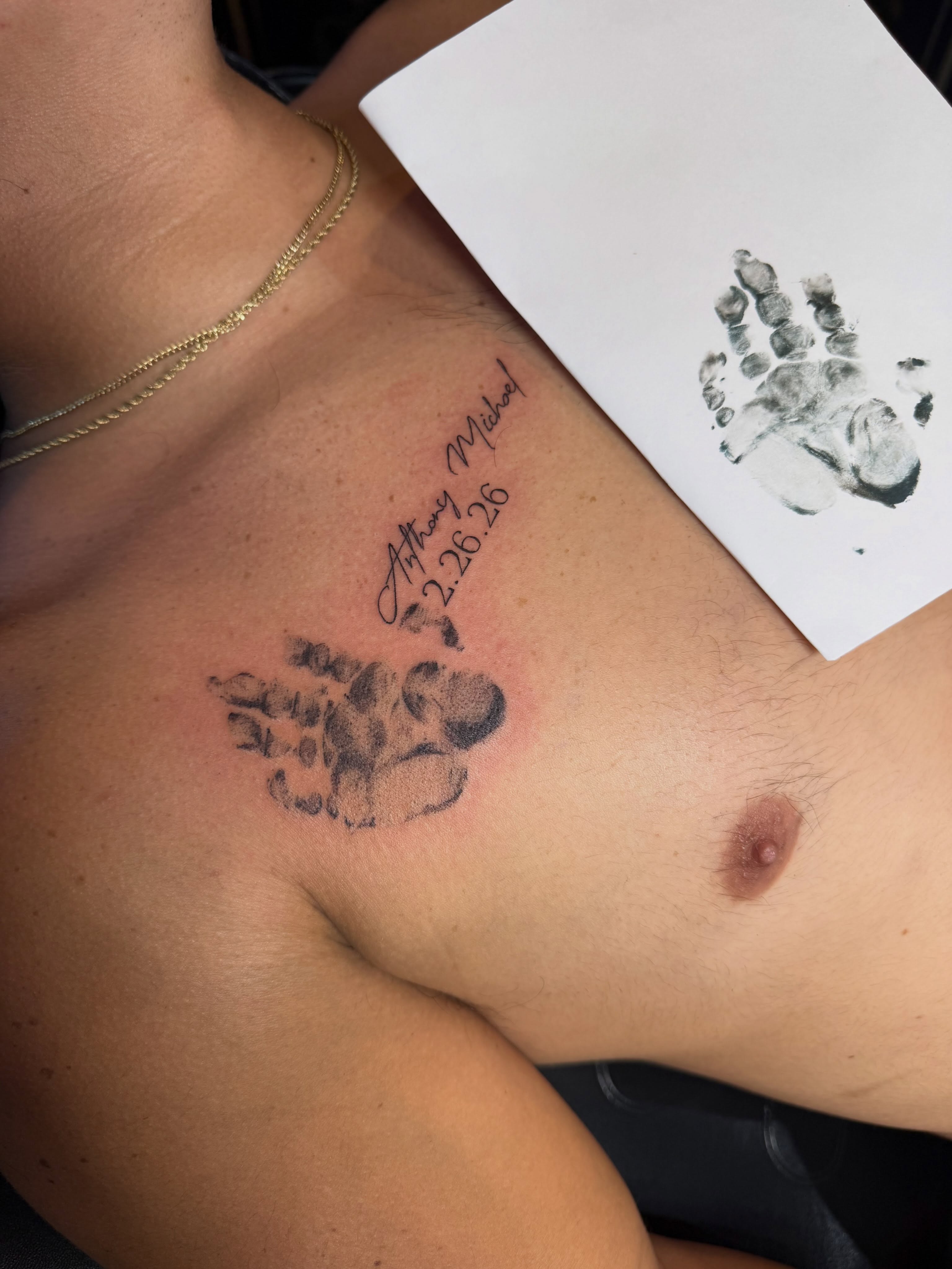 Baby handprint dotwork tattoo on the chest by Michela's Tattoo's