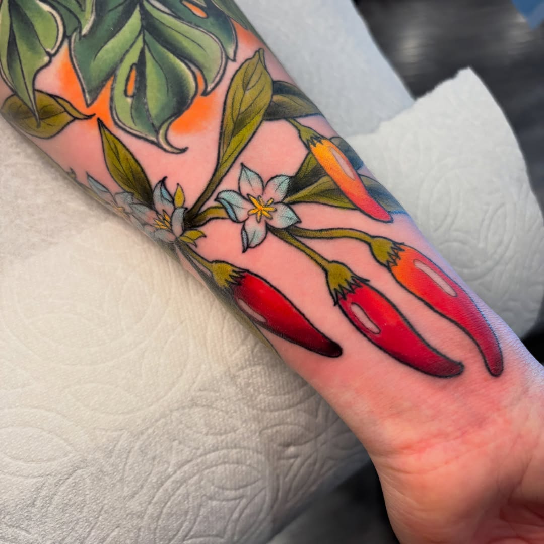 Chili peppers and flowers American traditional tattoo on the forearm by ✨REiD✨