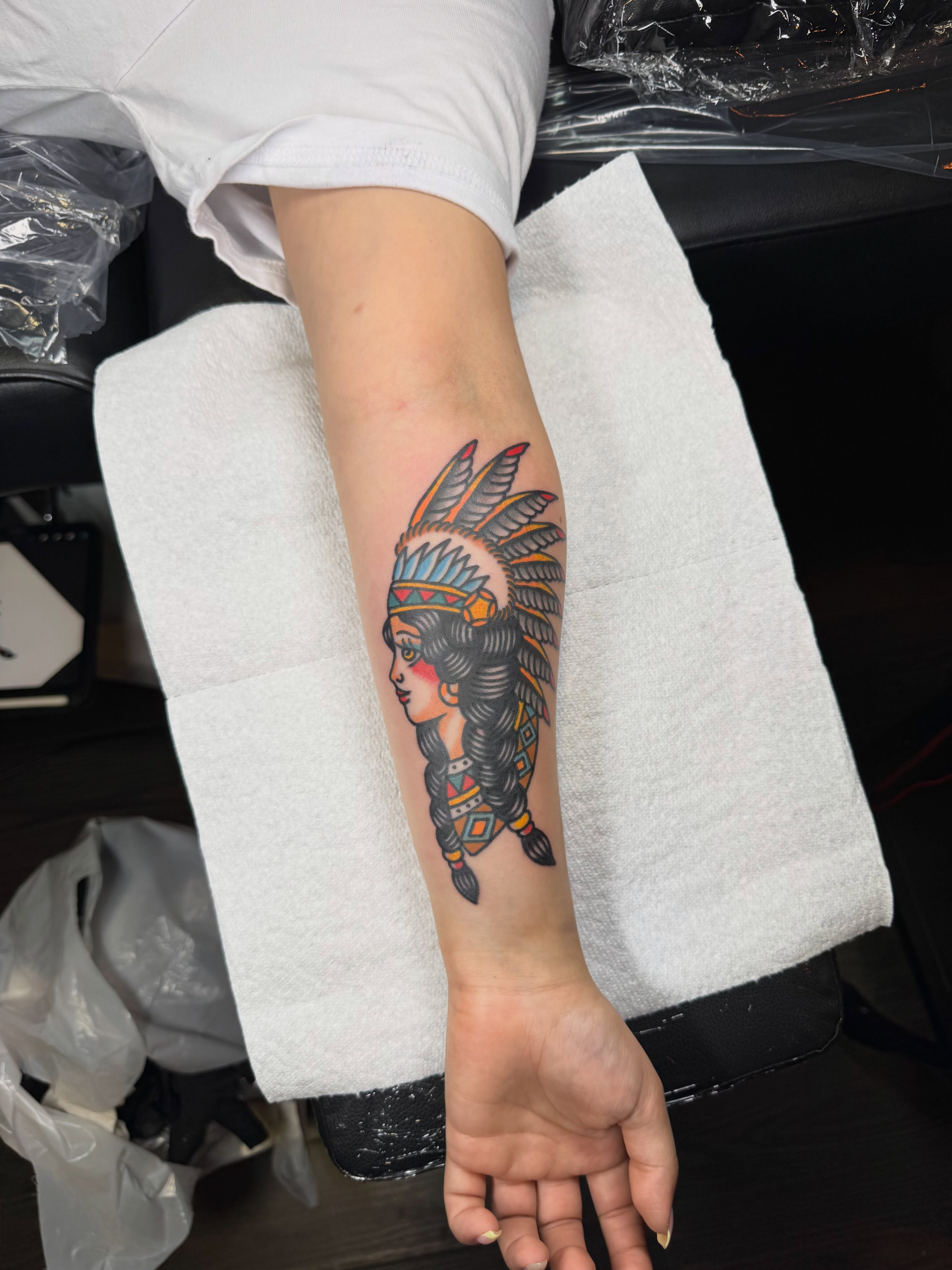 Indian headdress American traditional tattoo on the forearm by Oldschool Tattooer