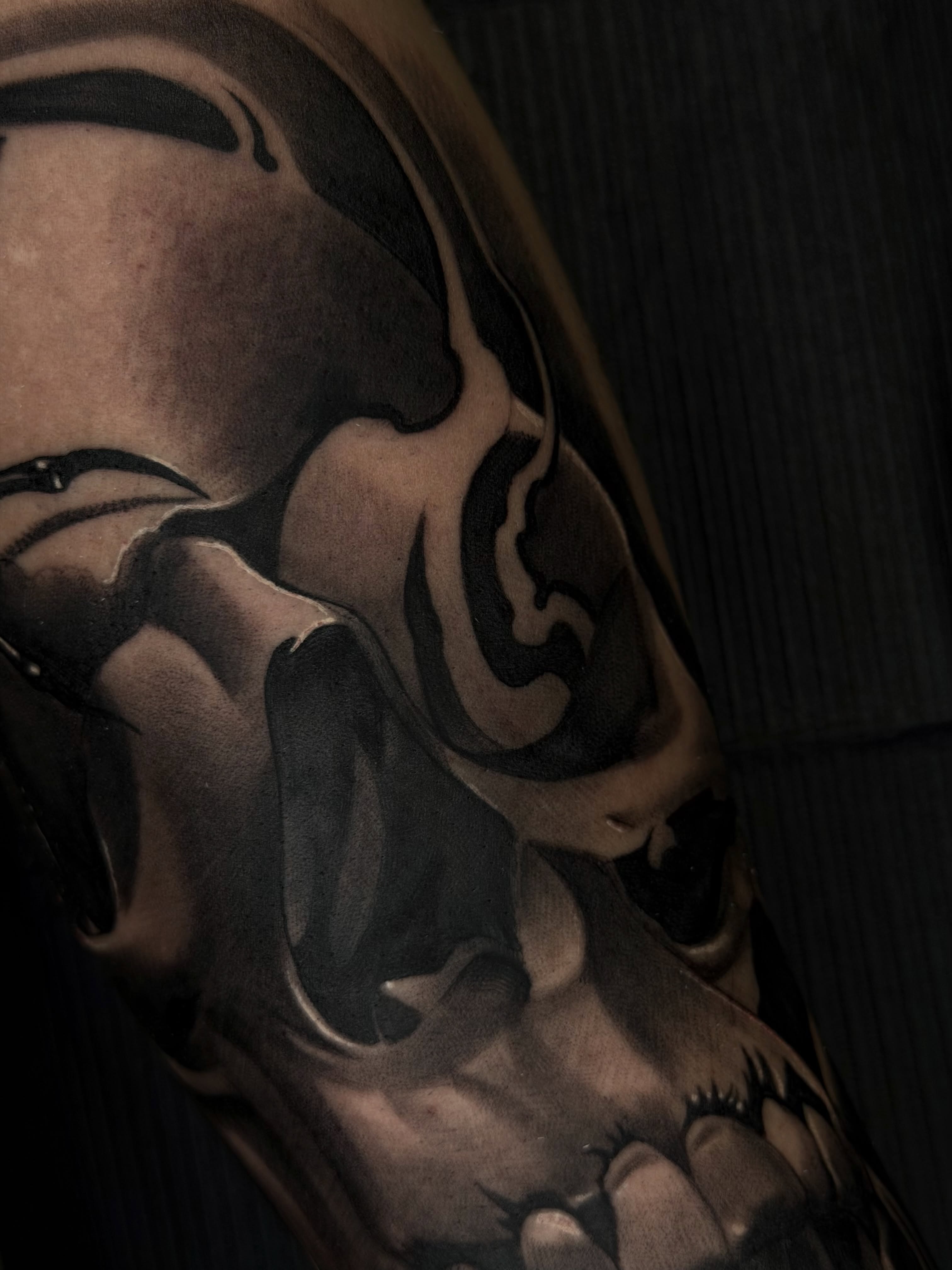 Skull dark realism tattoo on the upper arm by San Diego Tattoo Artist