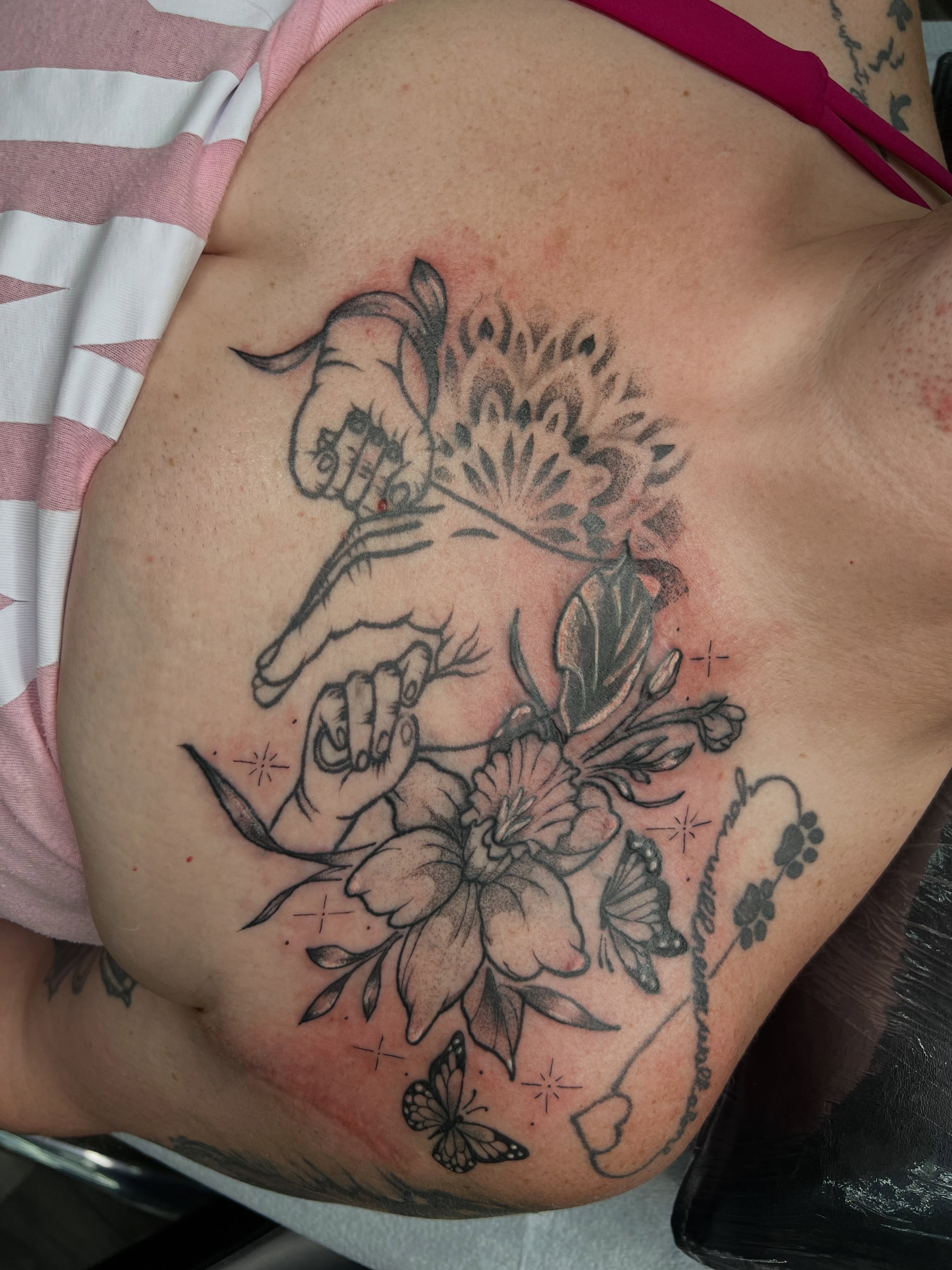 Floral arrangement with hands black and grey tattoo on the chest by Monii Arreola