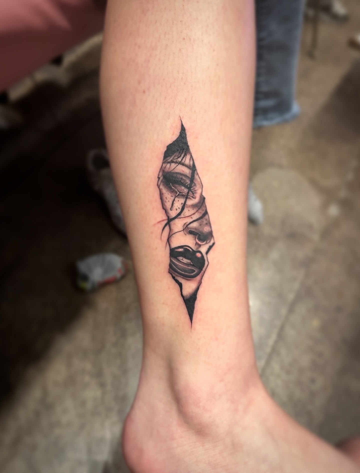 Abstract face realism tattoo on the forearm by Elizabeth’s Eclectic Tattoos